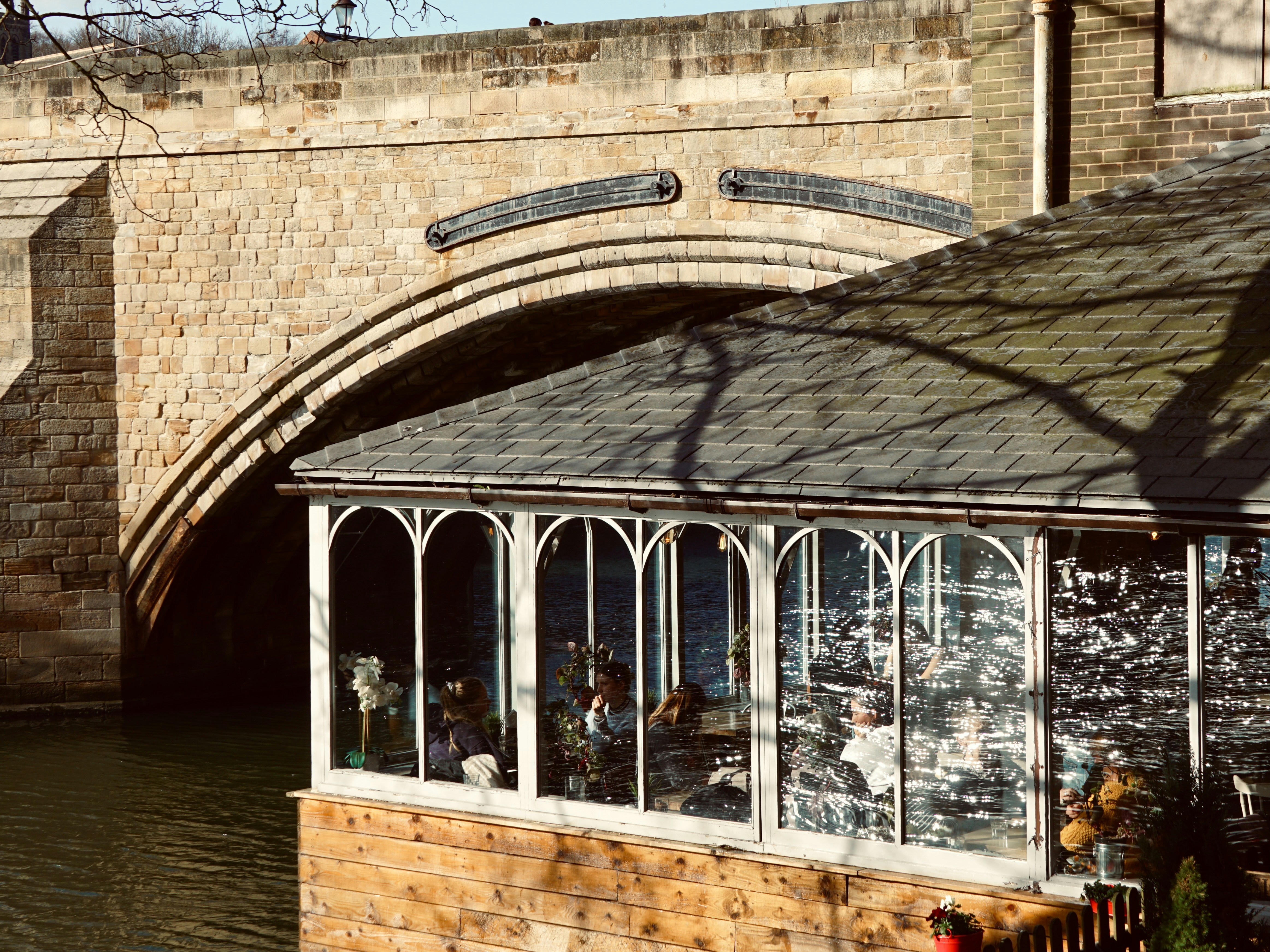 A bridge arches over a building with windows