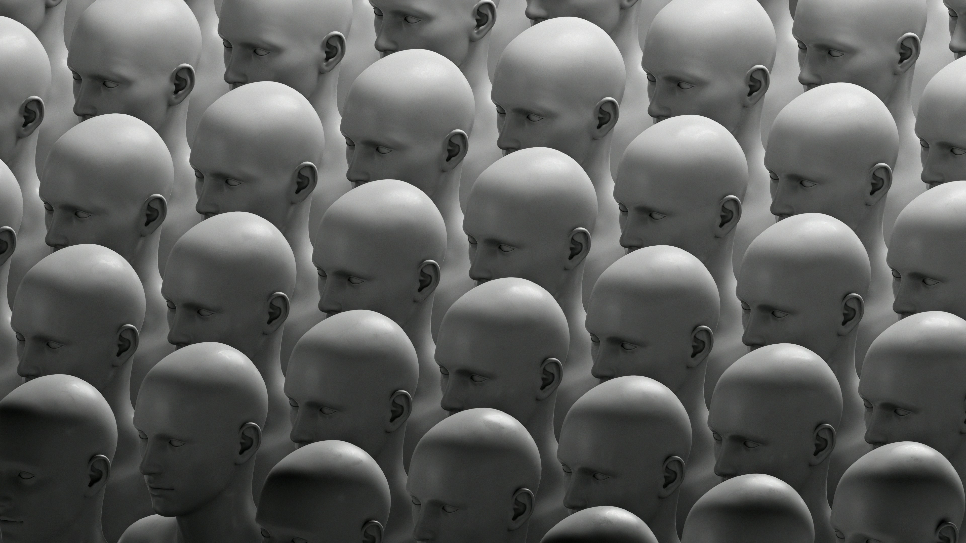 Alt text: Multiple identical heads arranged in a grid pattern, representing uniformity and collective ideas for Branimo.