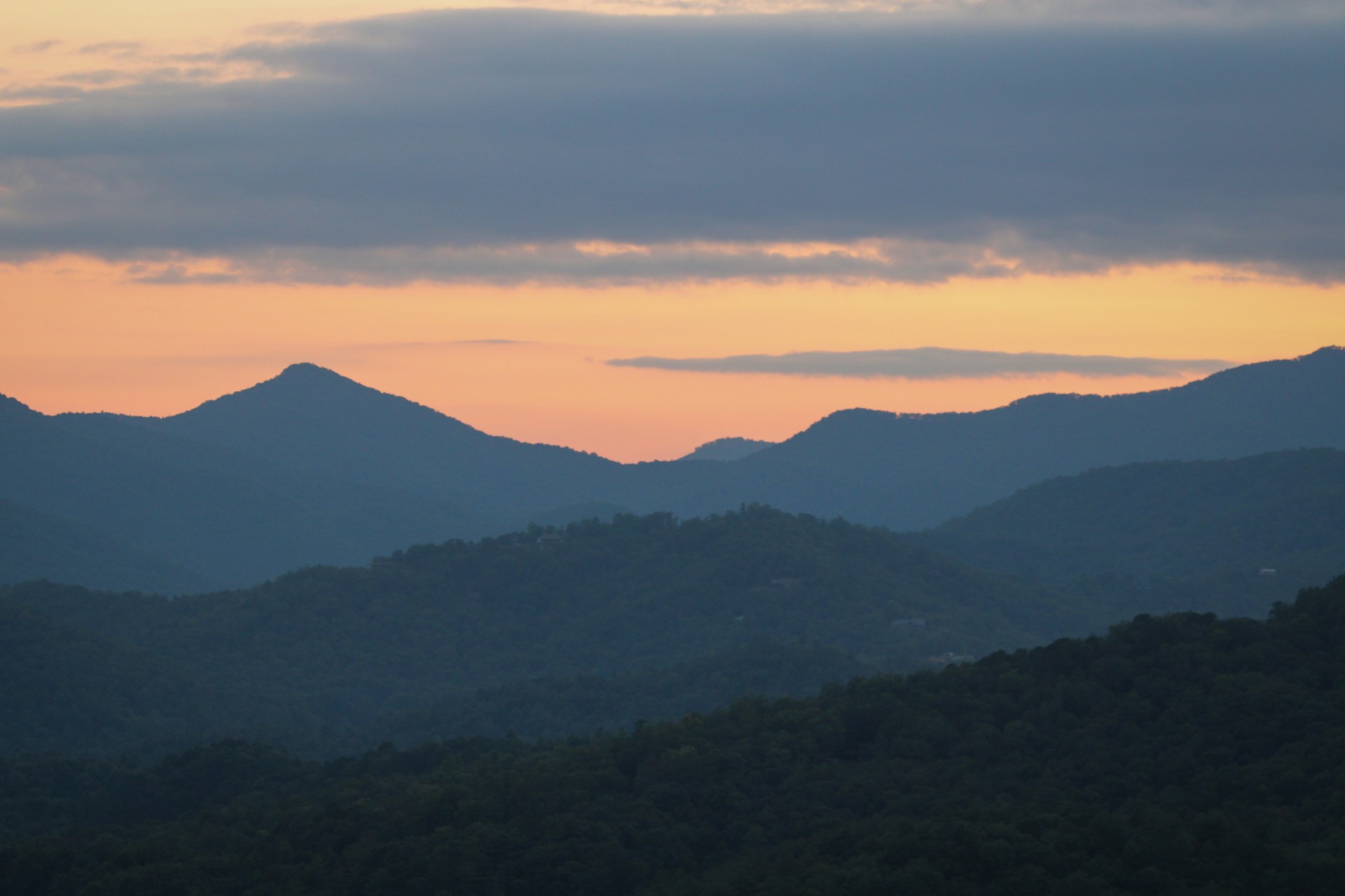 Mountains silhouette the sunset sky beautifully.