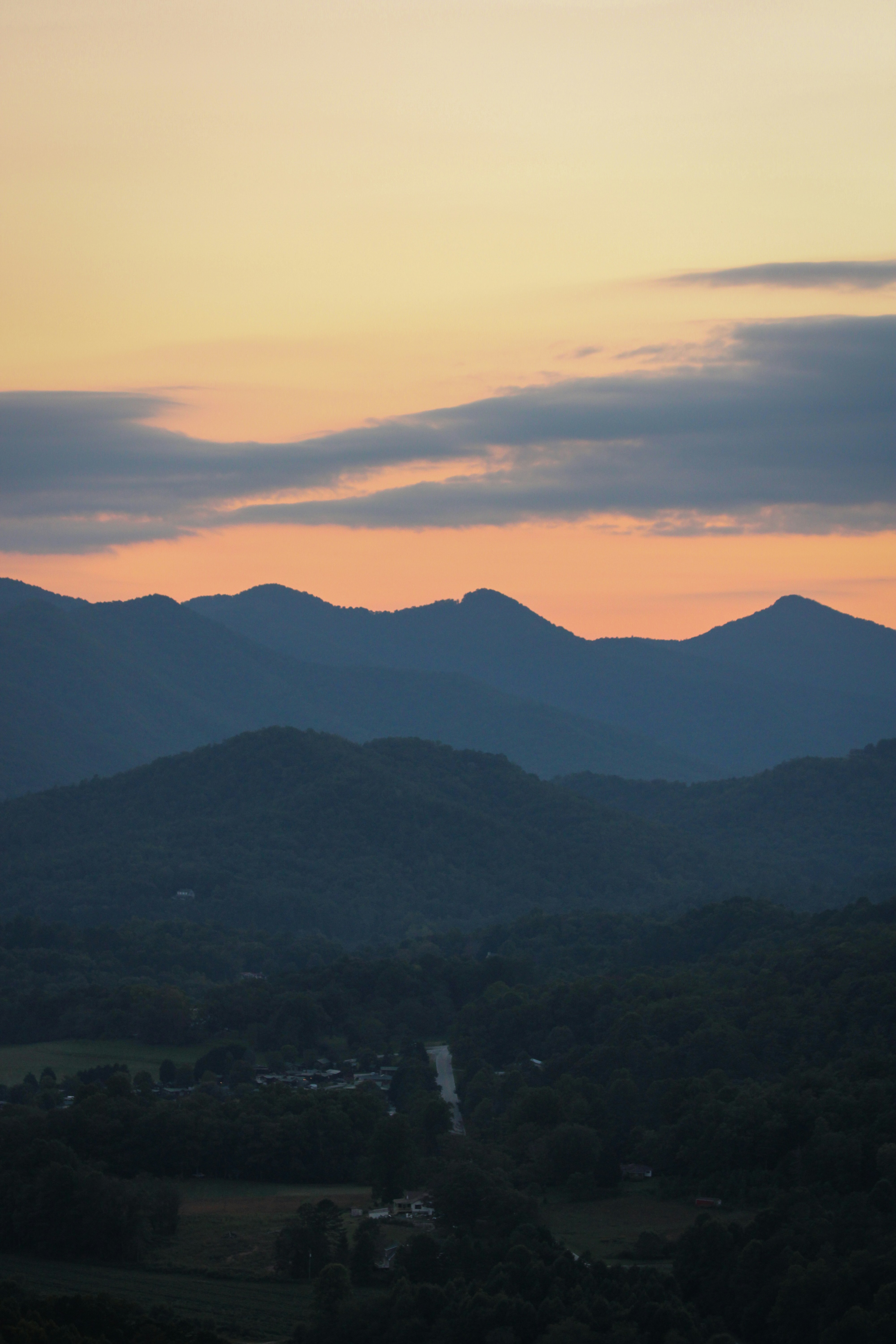 Mountains silhouetted against a colorful sunset sky.