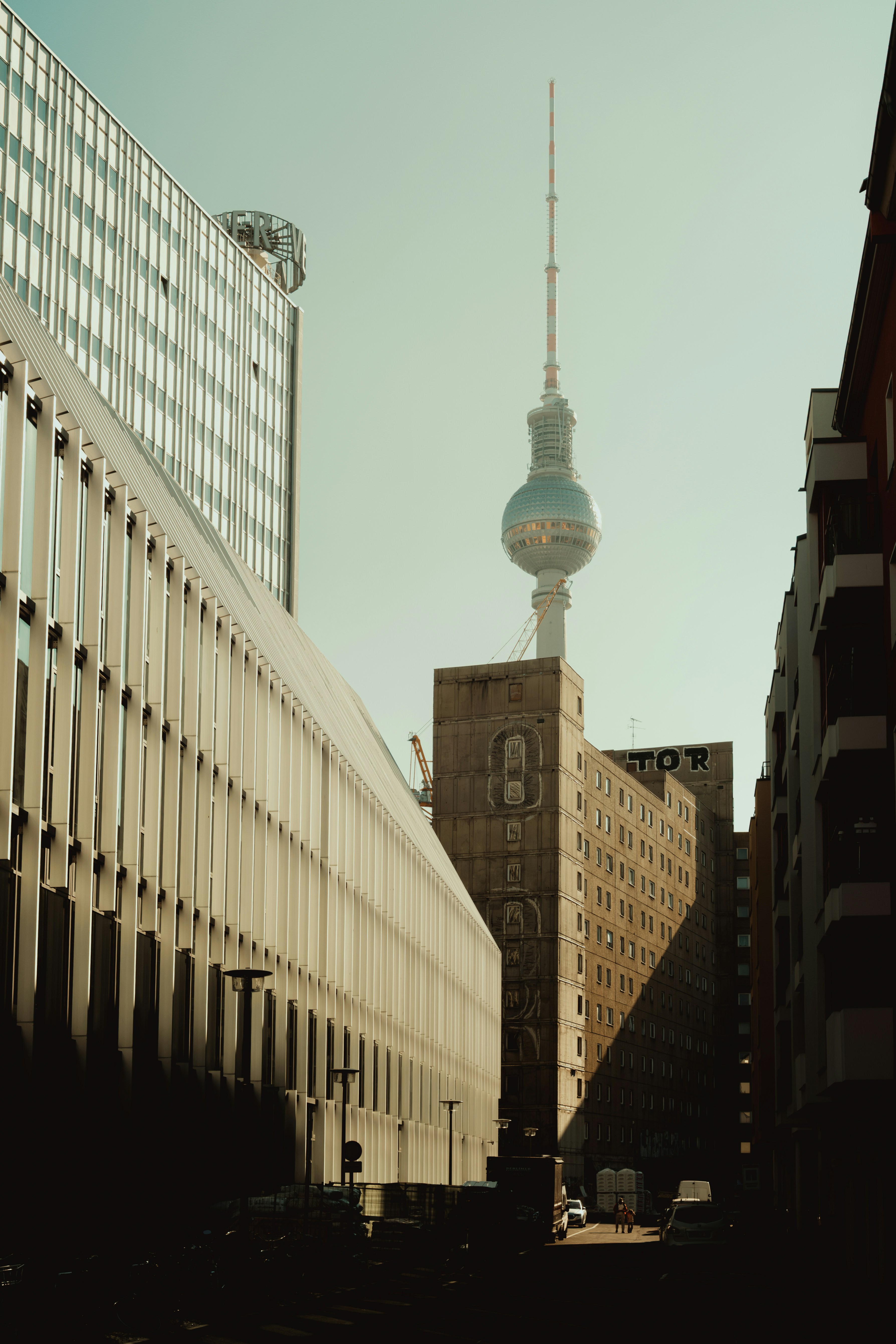 The berlin TV tower rises above buildings.
