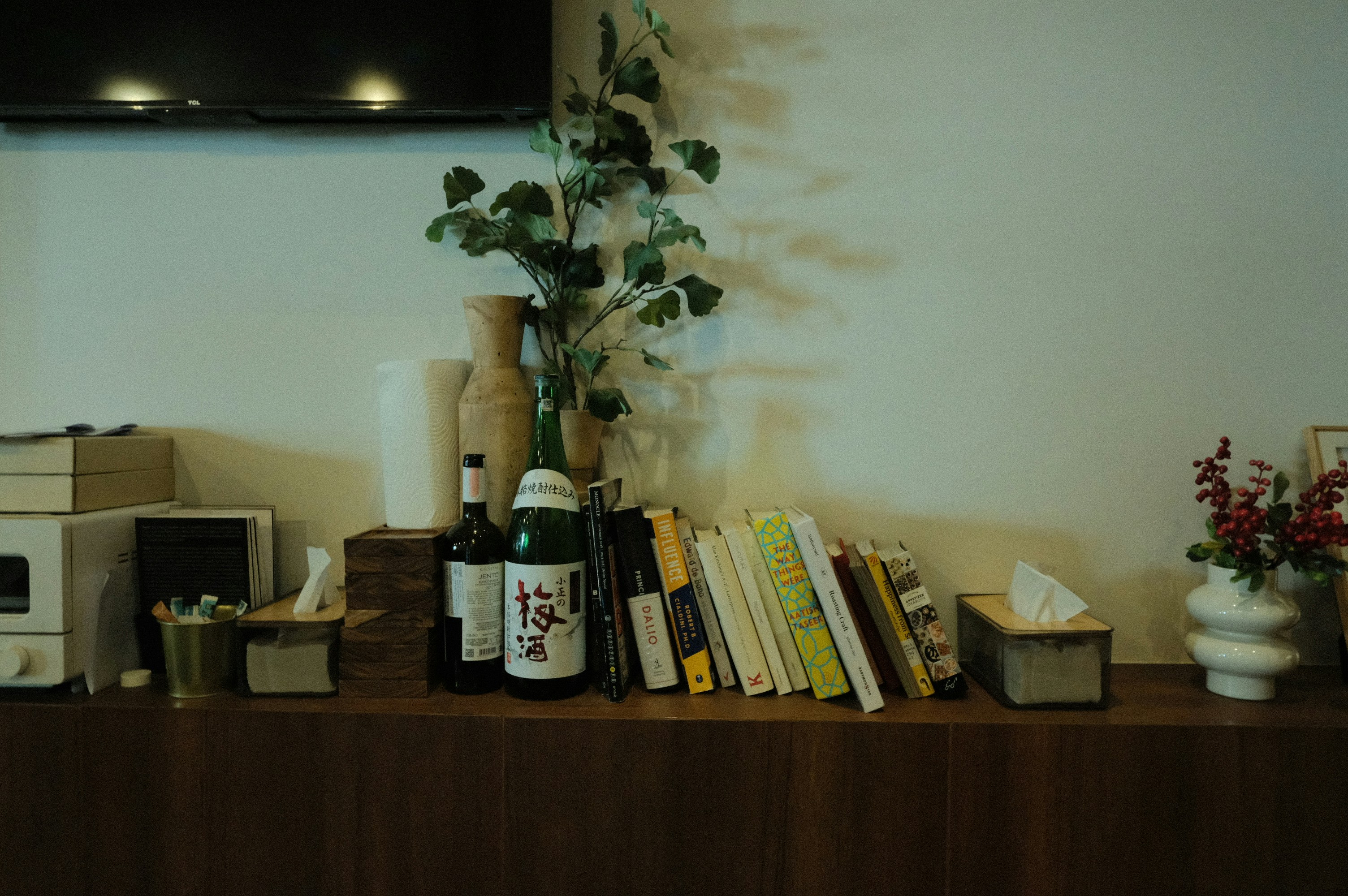 Books and decor on a wooden shelf.