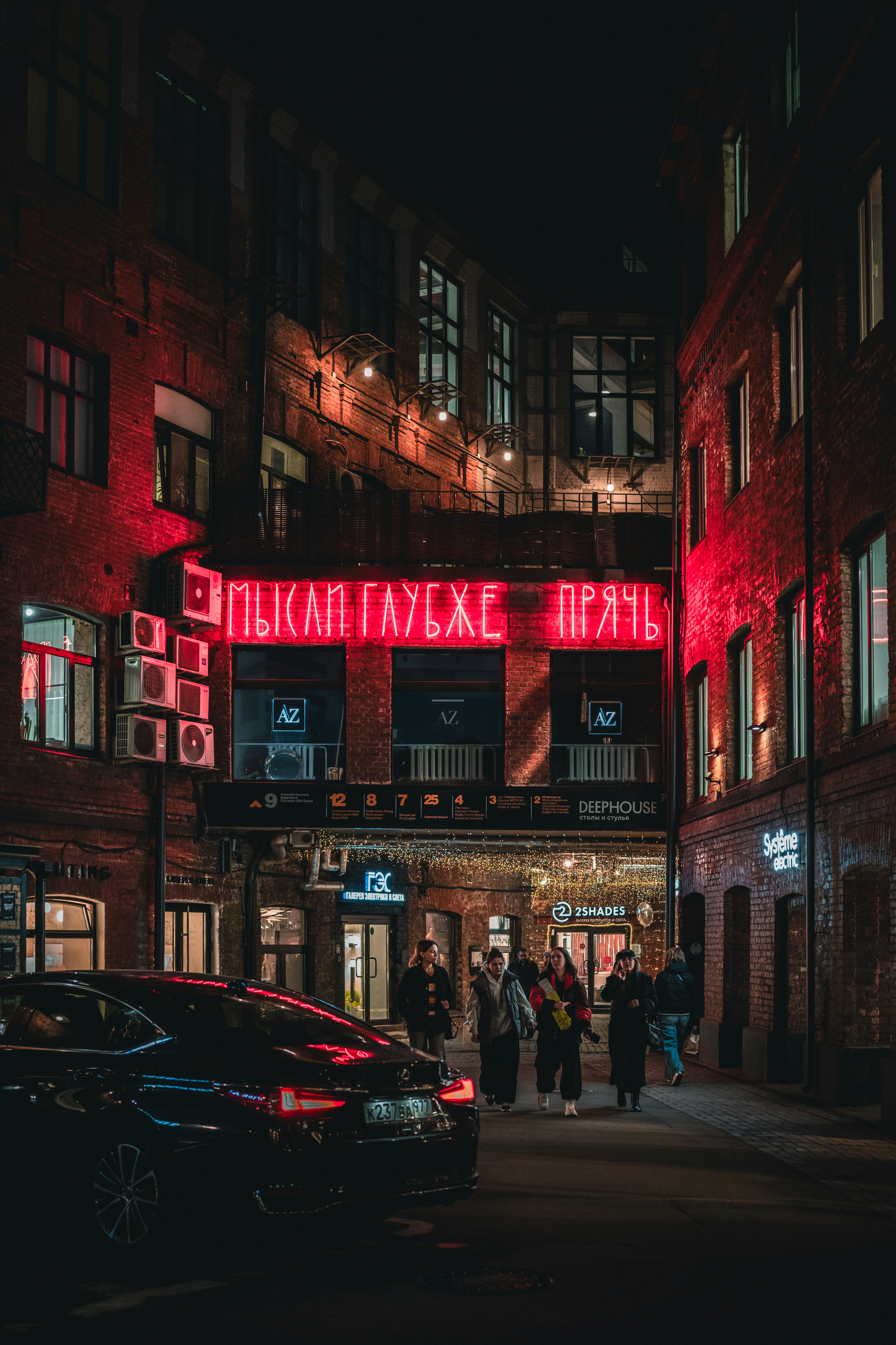 Night scene in an alleyway with red neon.