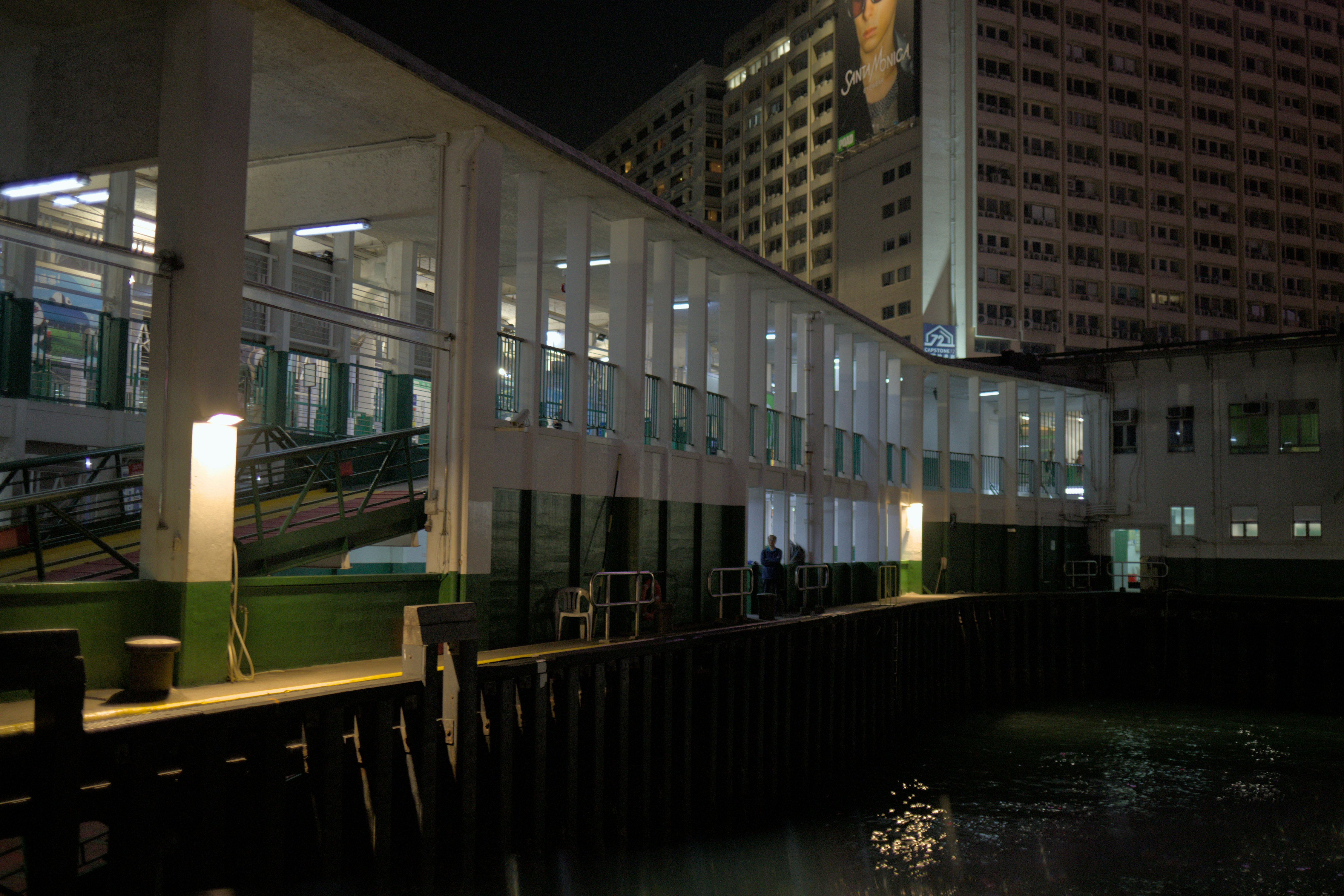 Night view of a pier with buildings.