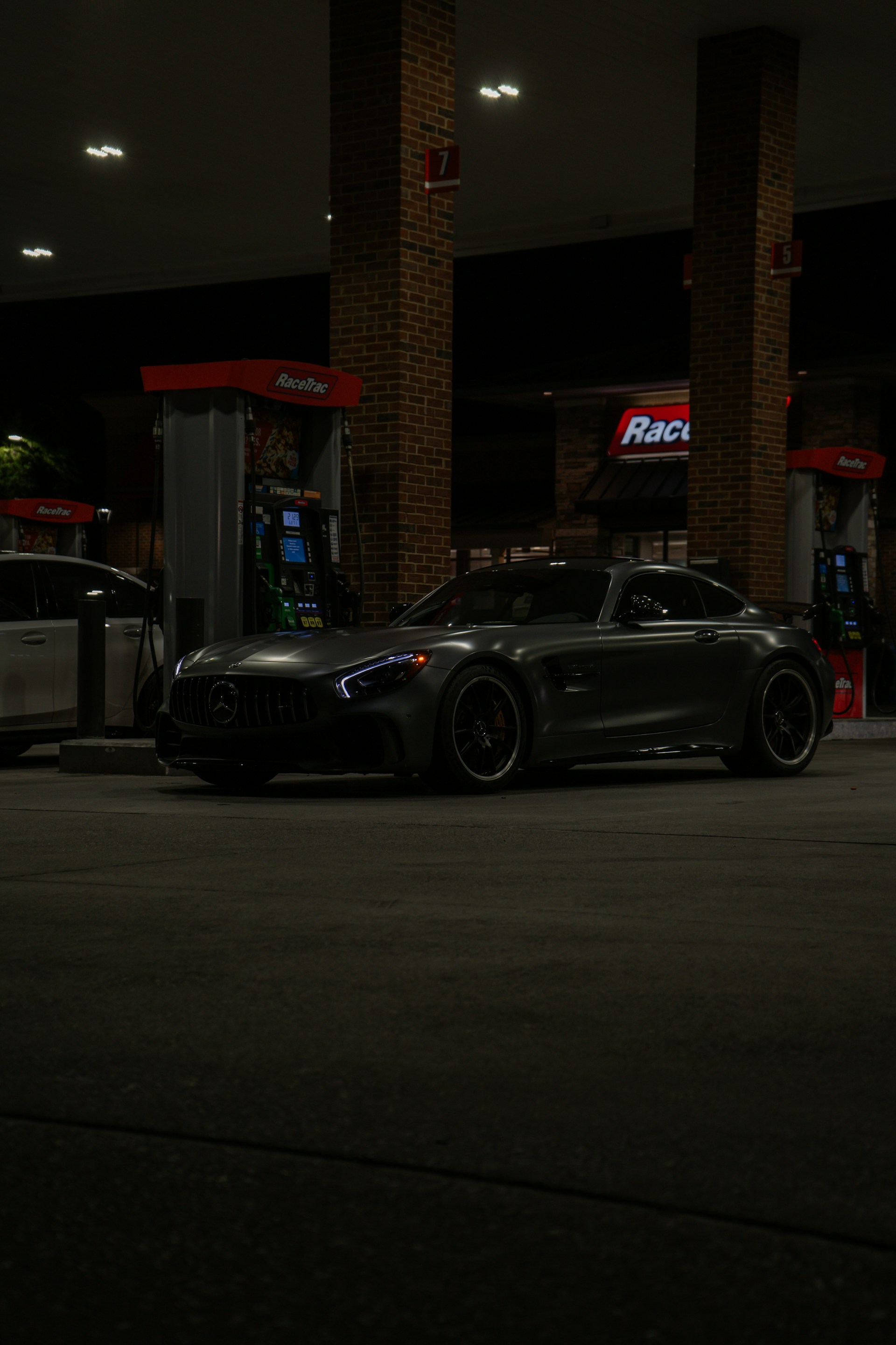 A sleek mercedes-amg parked at a gas station.