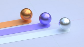 Three colored spheres roll along different paths.