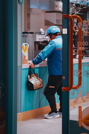Delivery person picks up an order at a store.