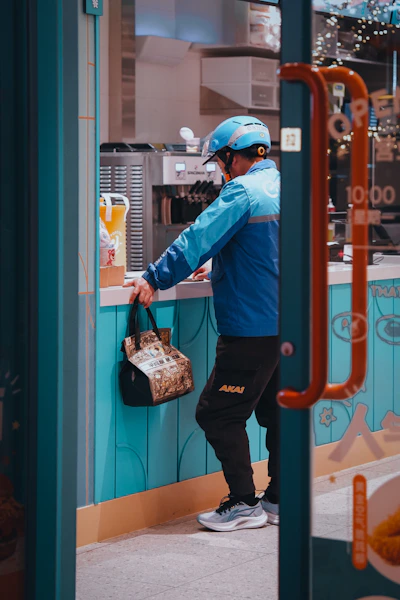 Delivery person picks up an order at a store.