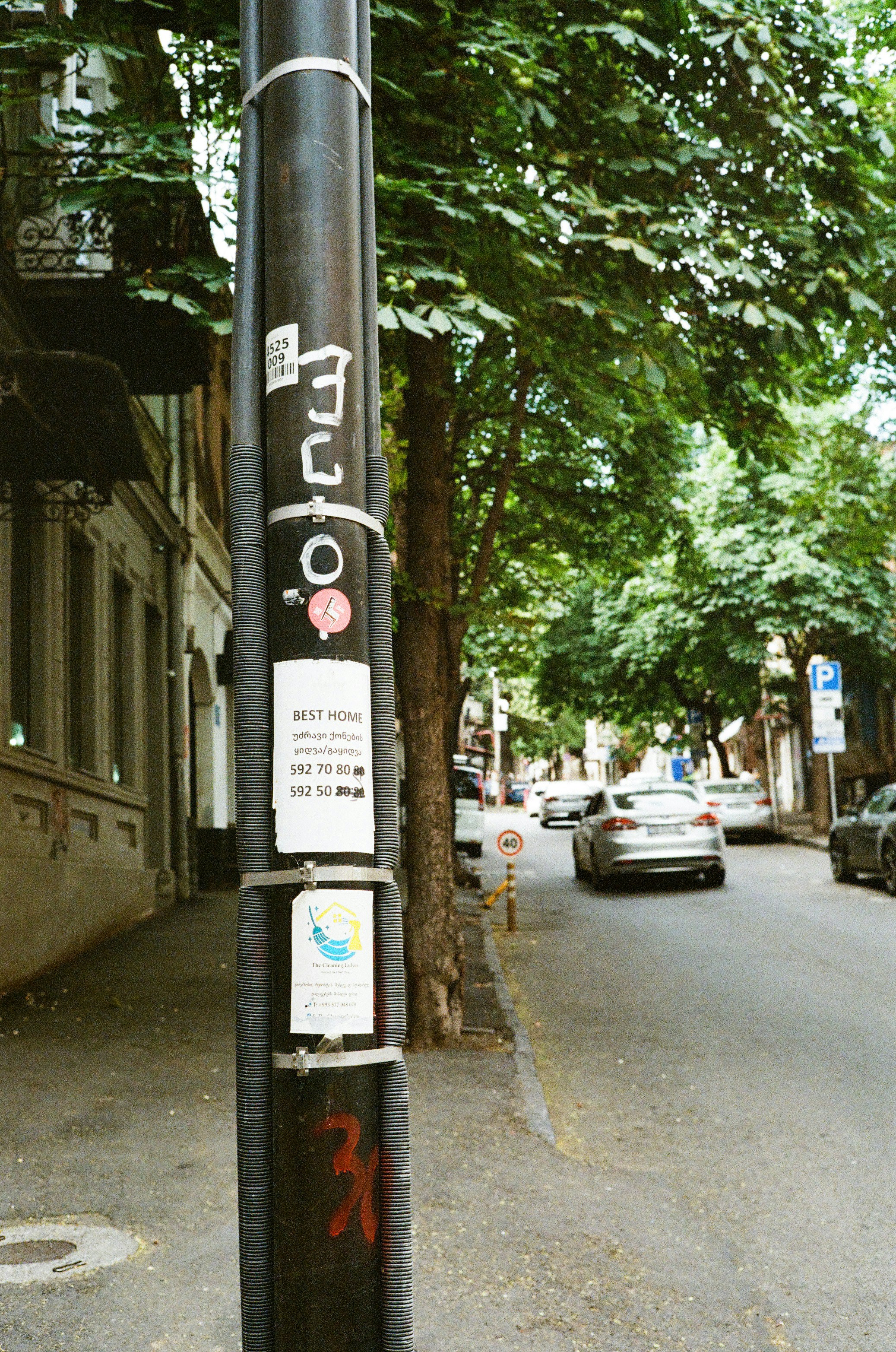A street with a pole and some cars.