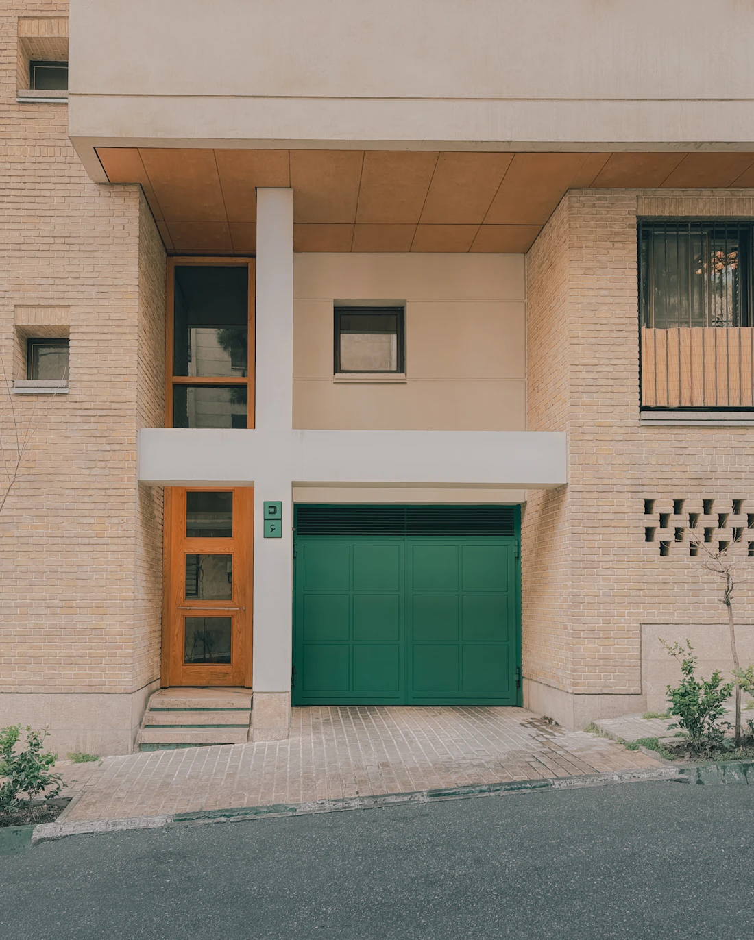 Modern building with a teal commercial-style garage door