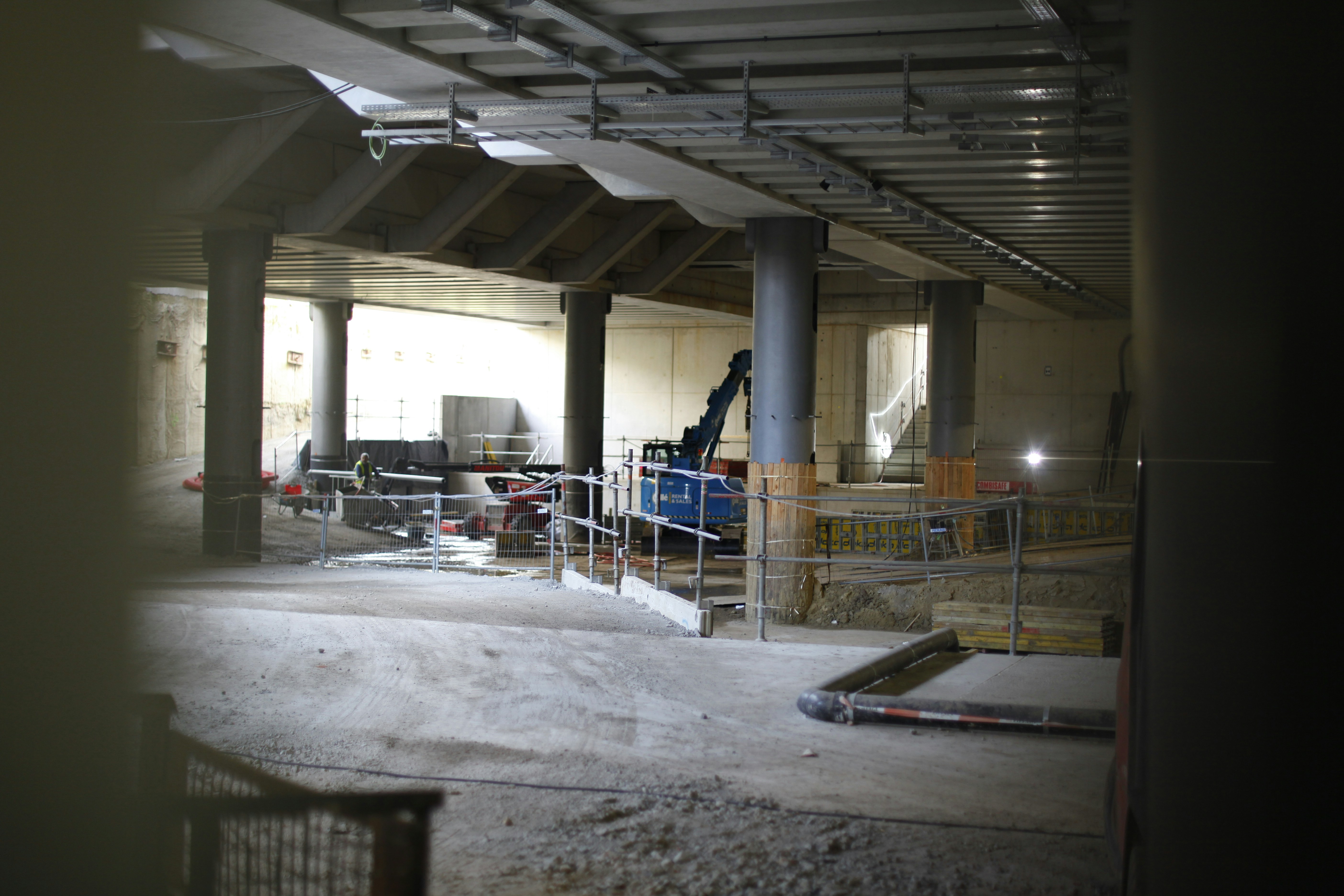 Underground construction site with columns and machinery.