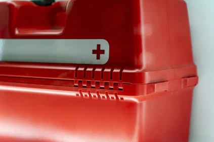 A red first aid kit is shown.