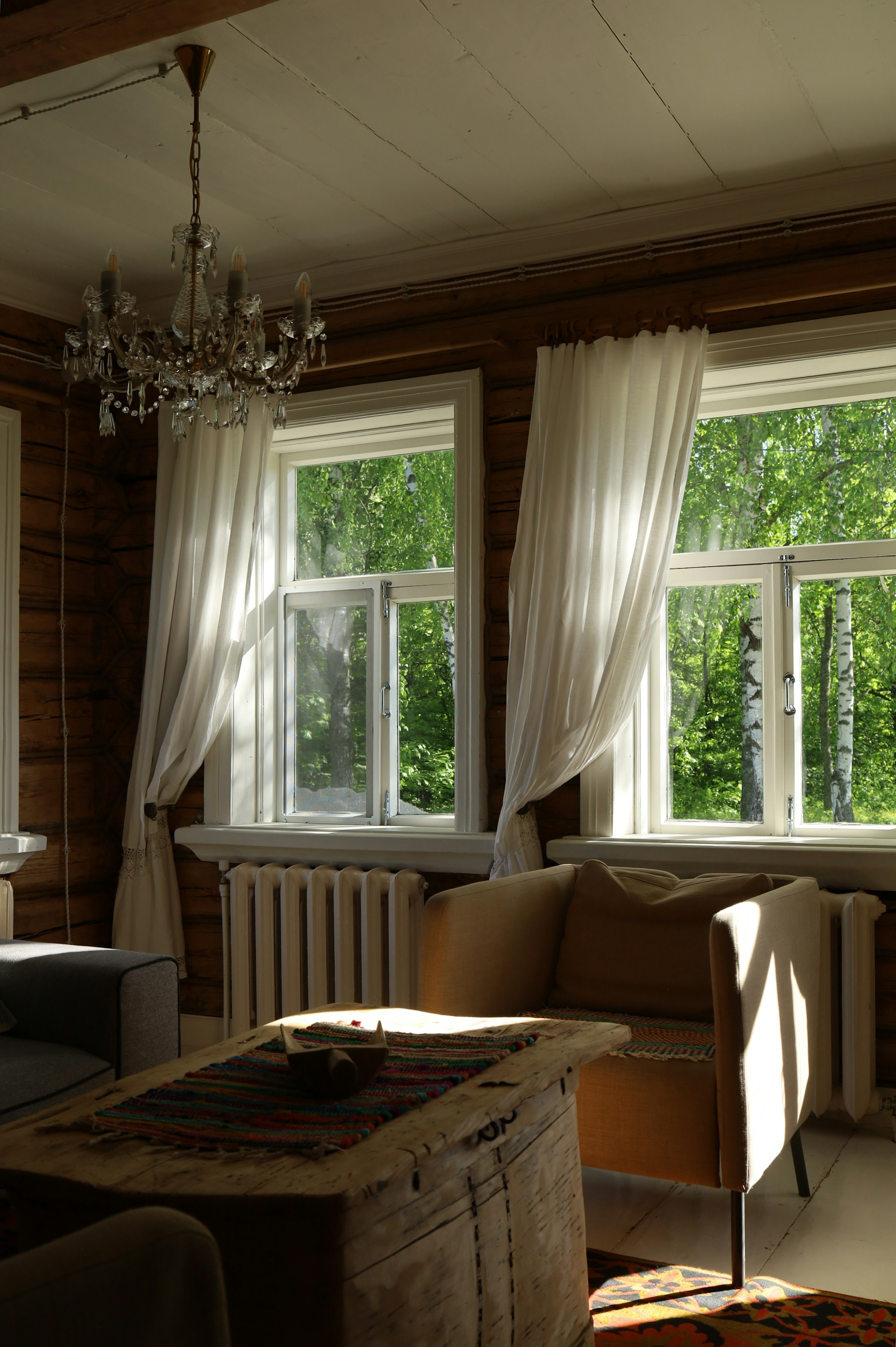 Sunlight floods a rustic living room with a view.