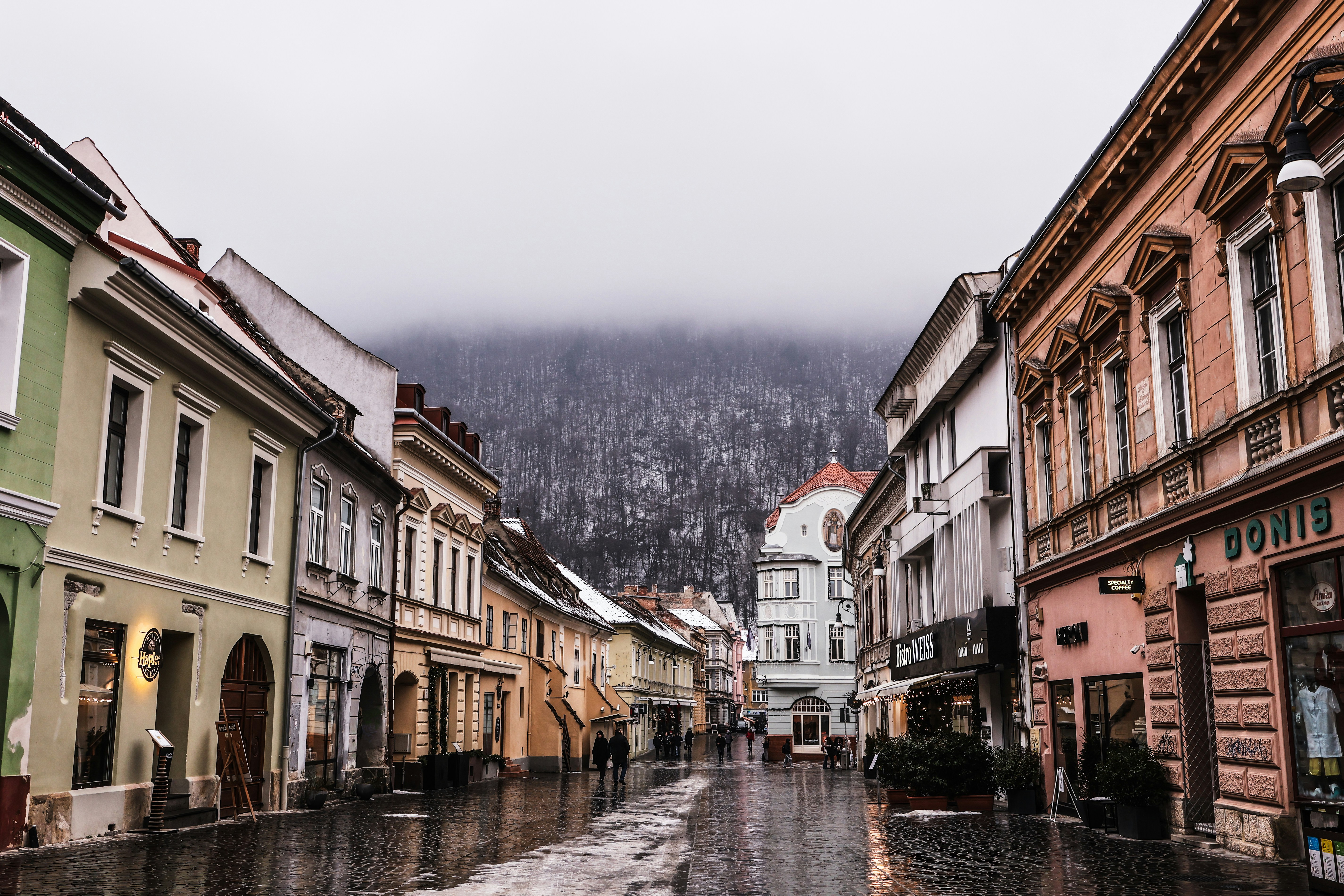 A european street lined with colorful buildings.