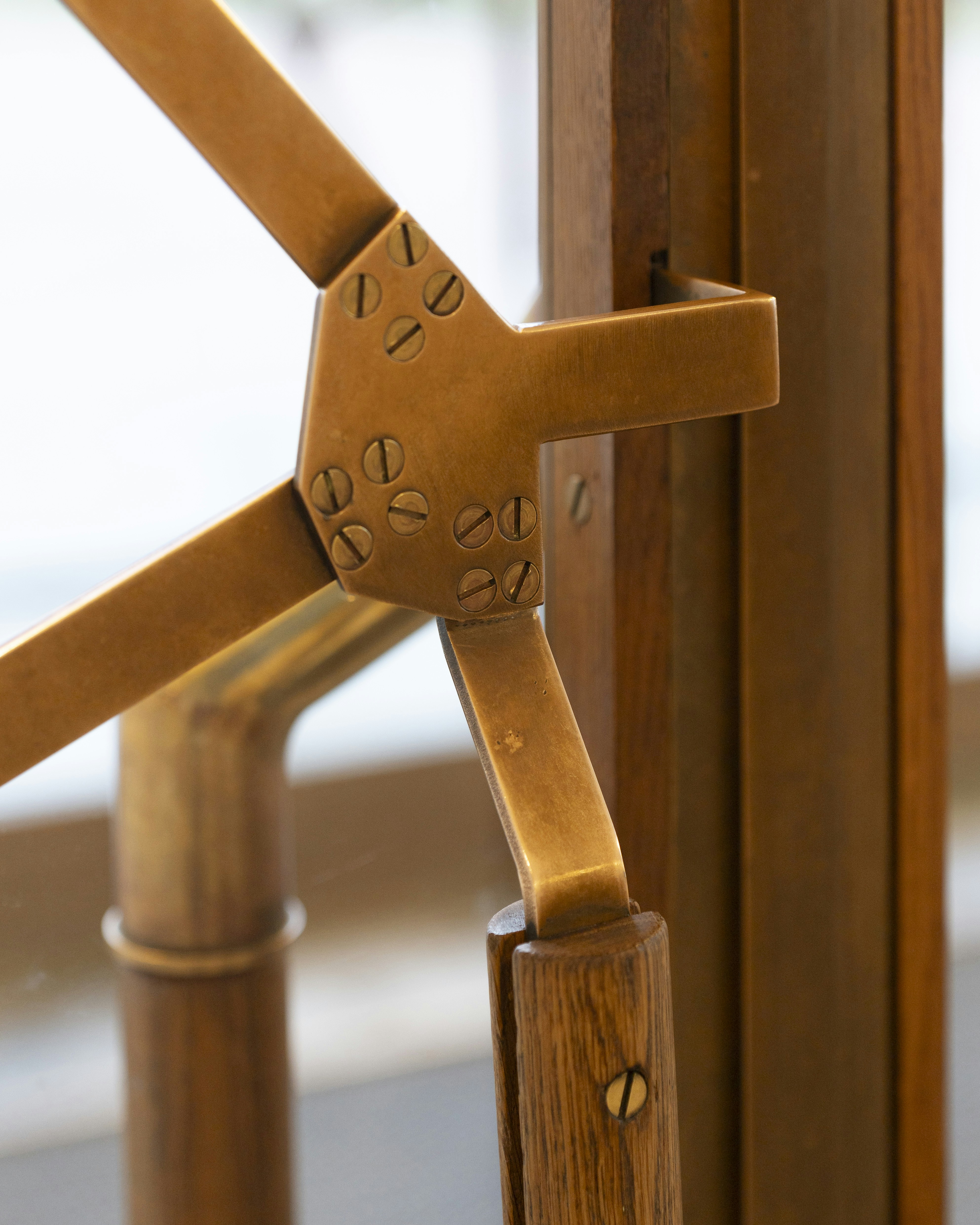 Wooden furniture with metal joints is shown.