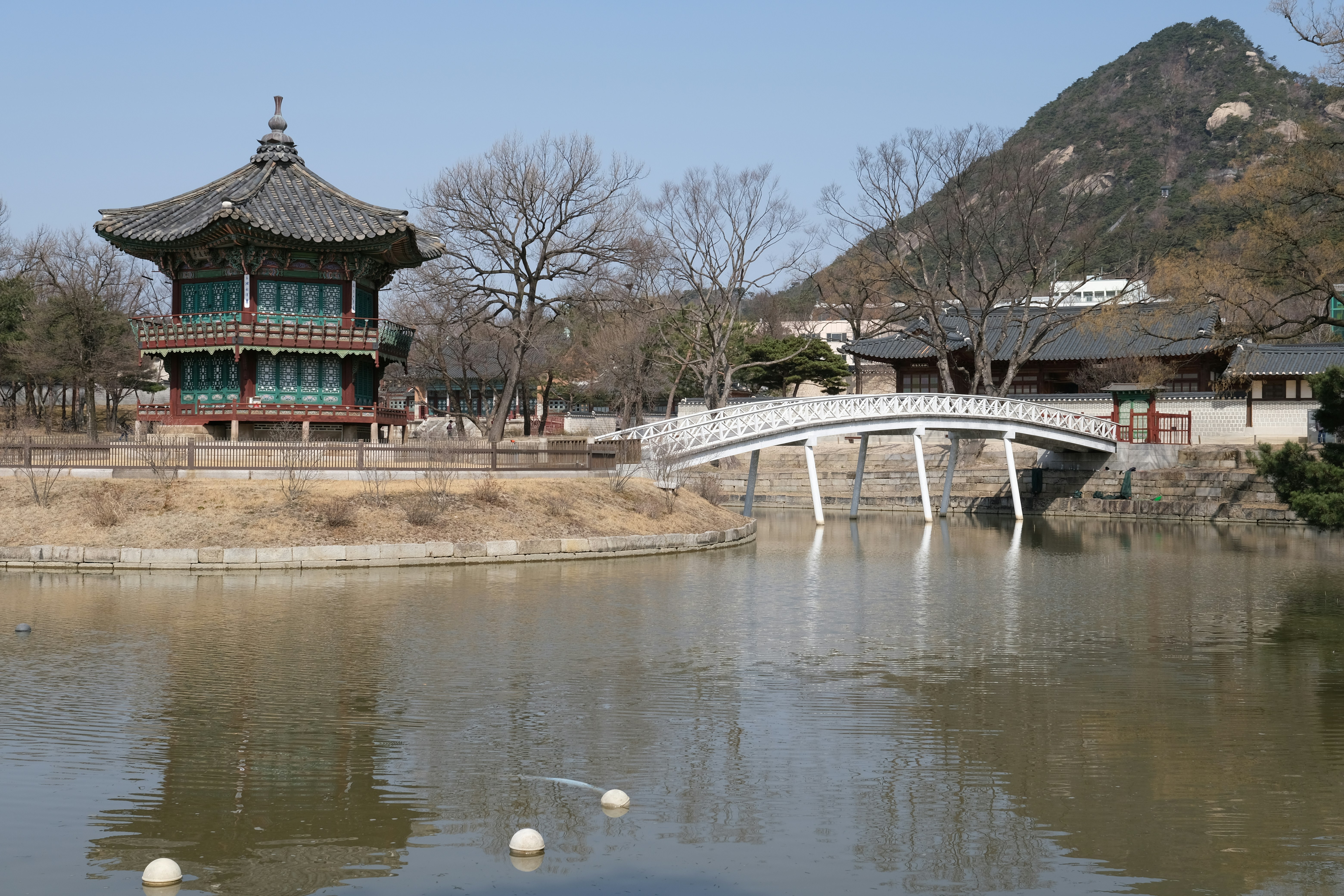 Traditional korean architecture reflects in the water.
