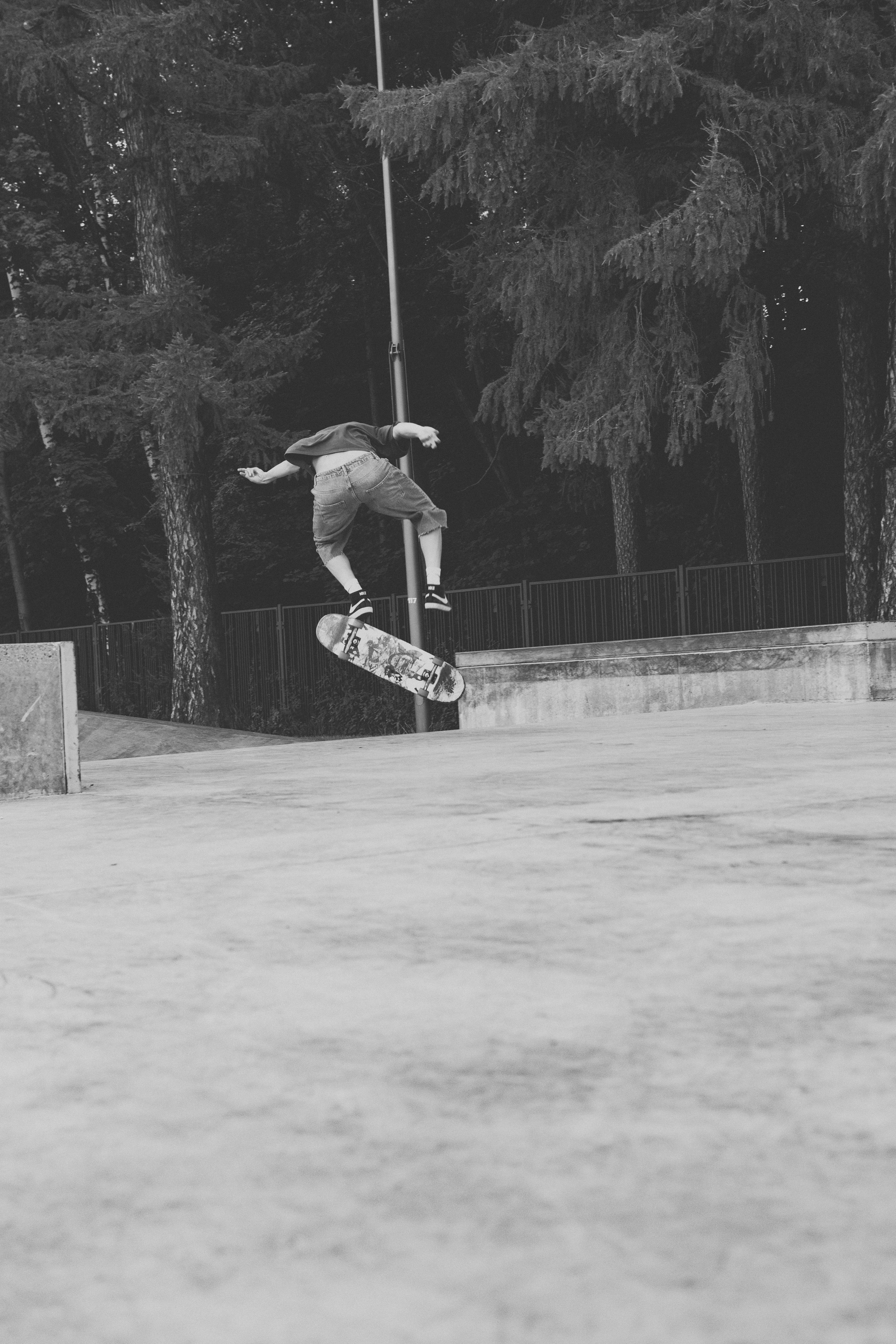 Skateboarder does an aerial trick in a skate park.