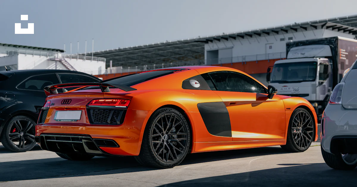 Audi R8 Track Version An orange audi r8 sits on a track. photo – Free Sports car Image on ...