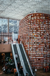 People explore a massive, book-filled library.