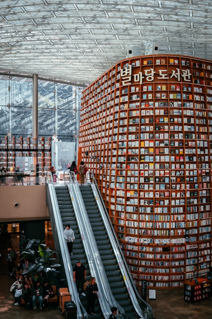 People explore a massive, book-filled library.