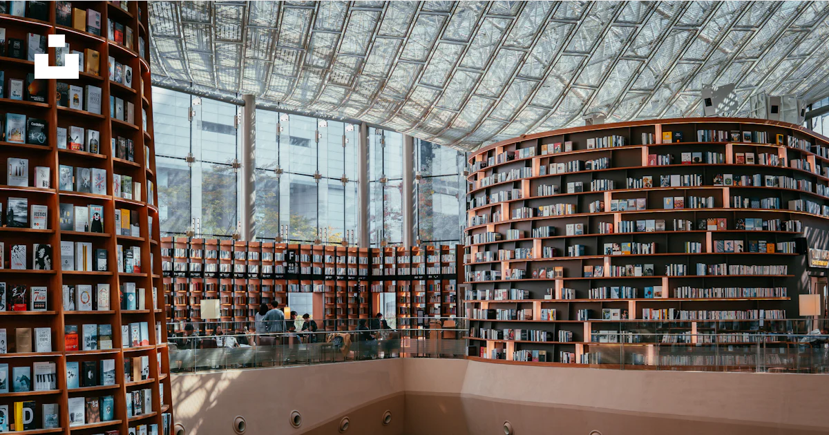 A large library has many bookshelves filled with books. photo – Free ...