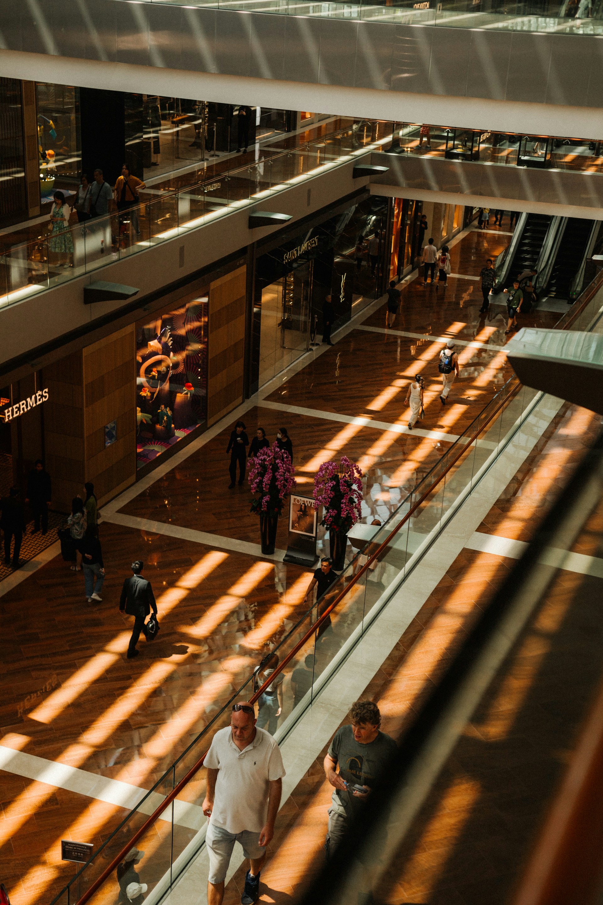 Sunlight bathes the interior of a multi-level mall.