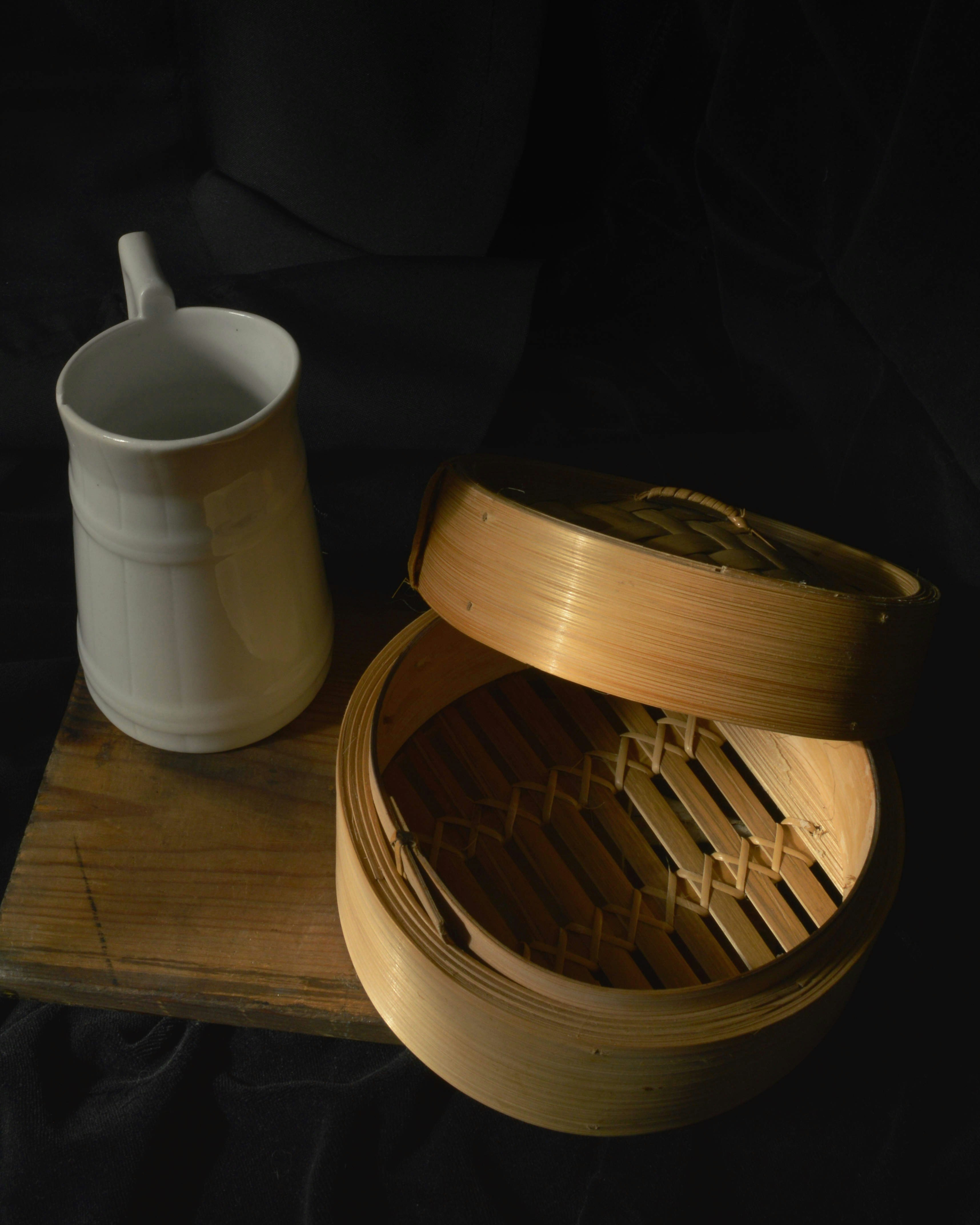 Mug and steamer sit on a wooden cutting board.