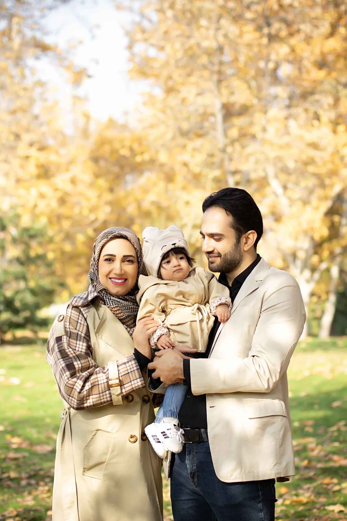A family poses together outdoors for a group photograph