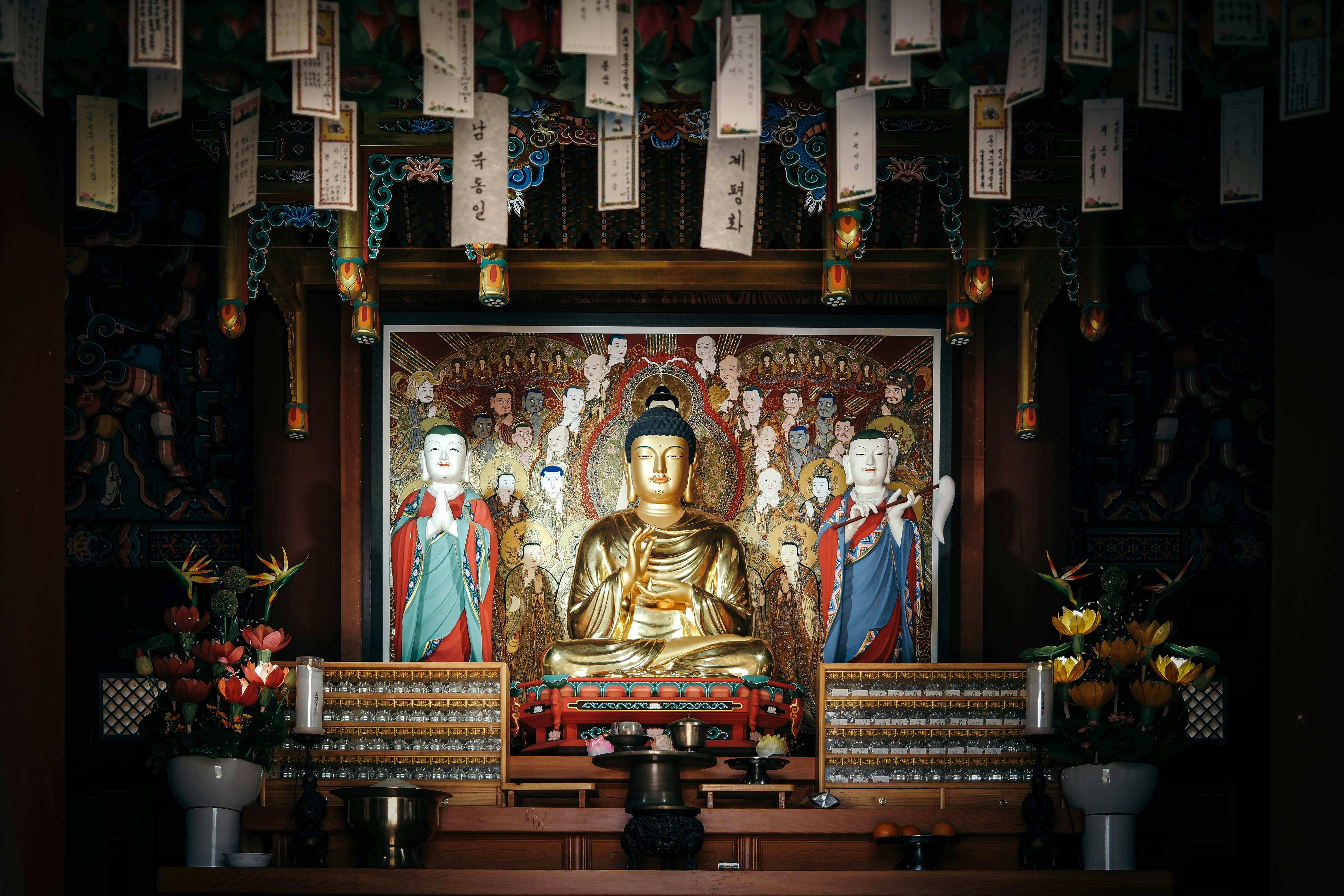 A golden buddha sits peacefully inside a temple.