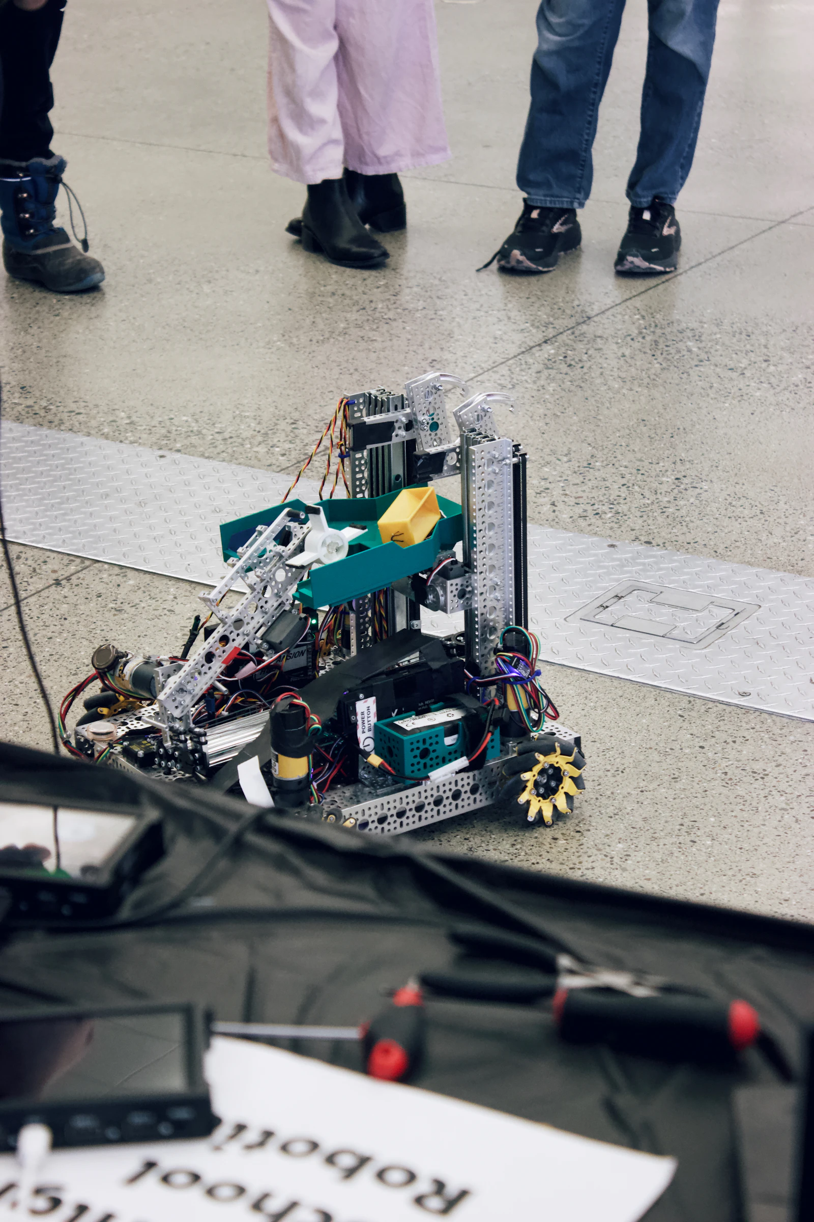 Students examining a robot prototype