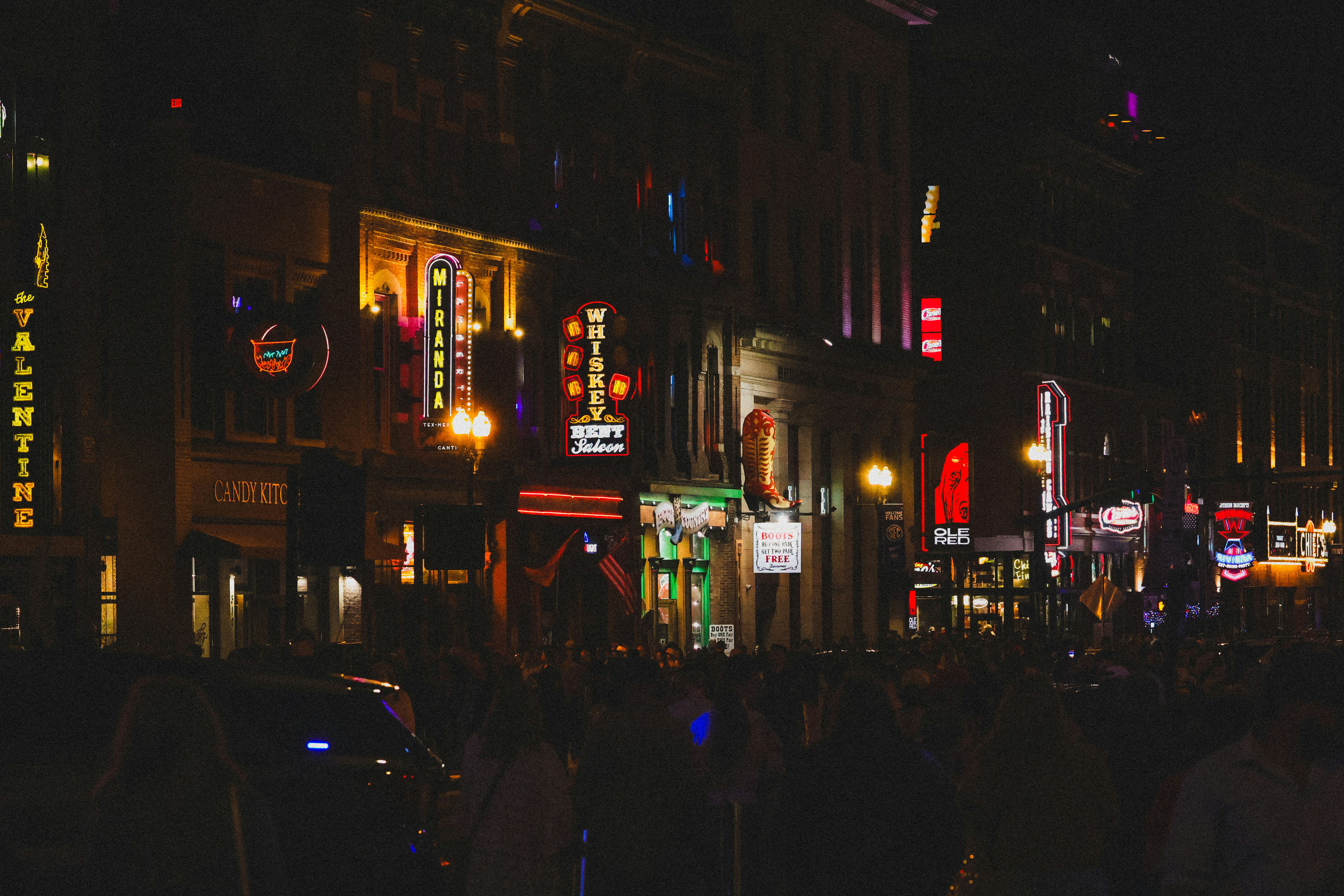 An inviting street scene in Uptown Chicago at dusk, with lights from local businesses glowing and people enjoying an evening stroll - best pizza Uptown Chicago