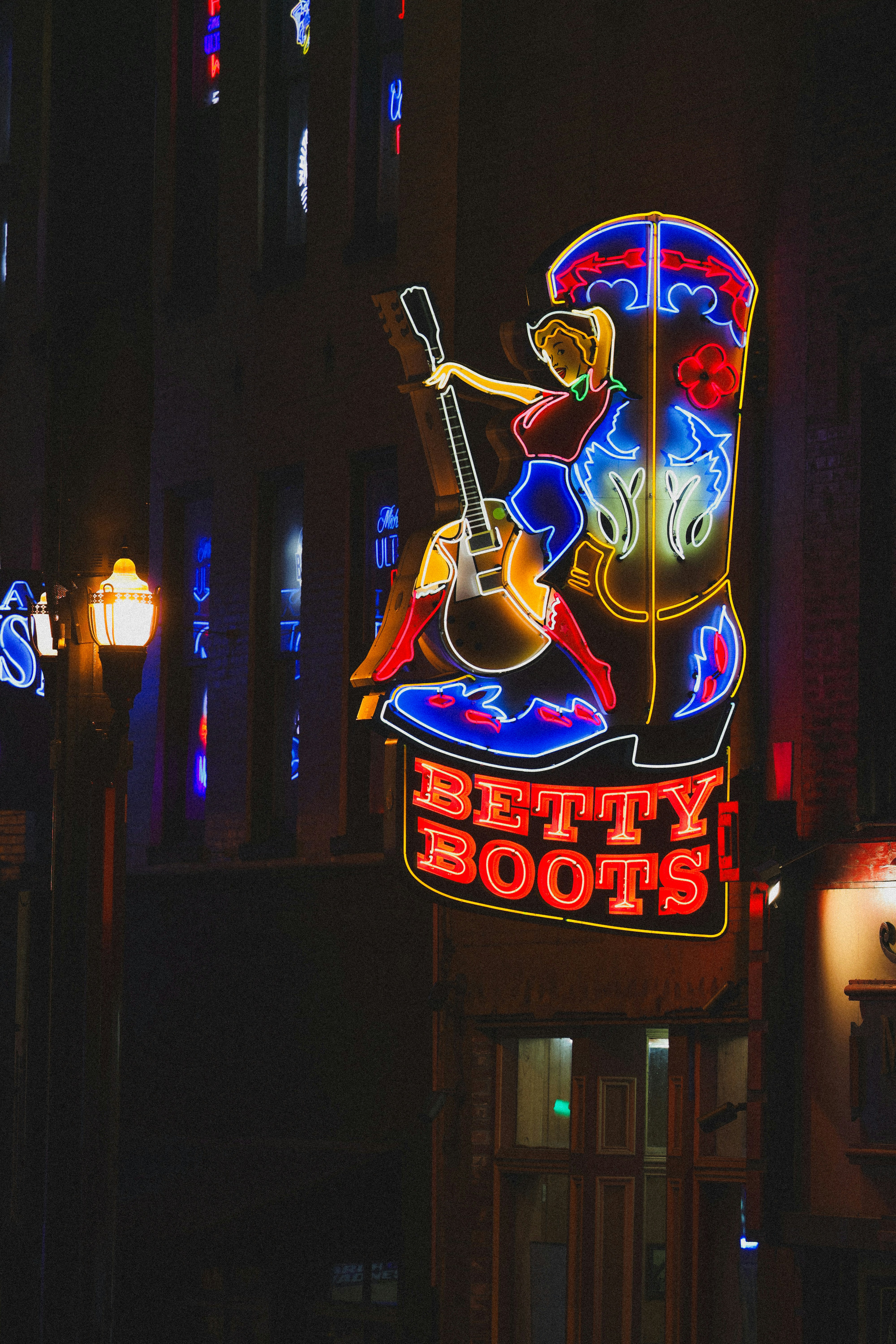 Neon sign of betty boots in the night.