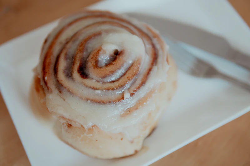 Glazed cinnamon roll on a plate