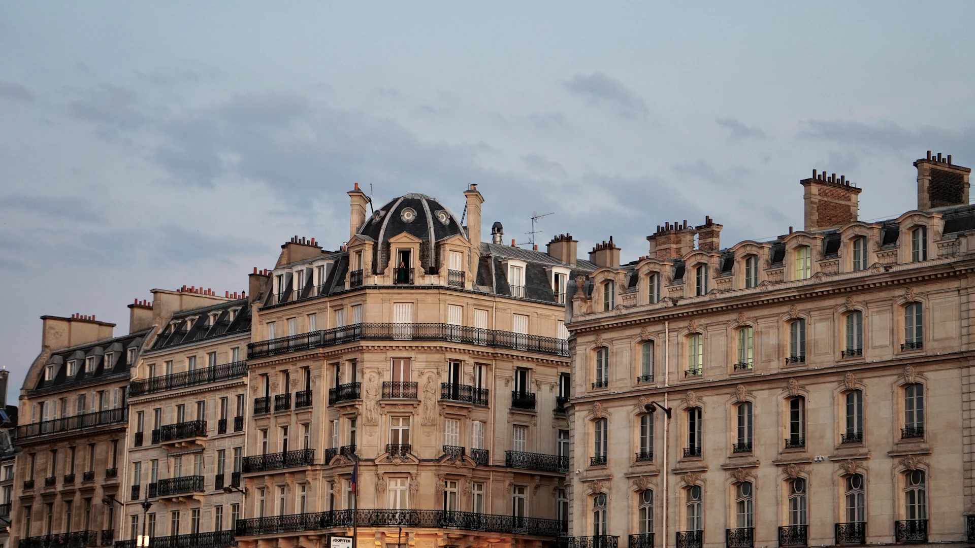 Elegant parisian buildings stand tall against the sky.