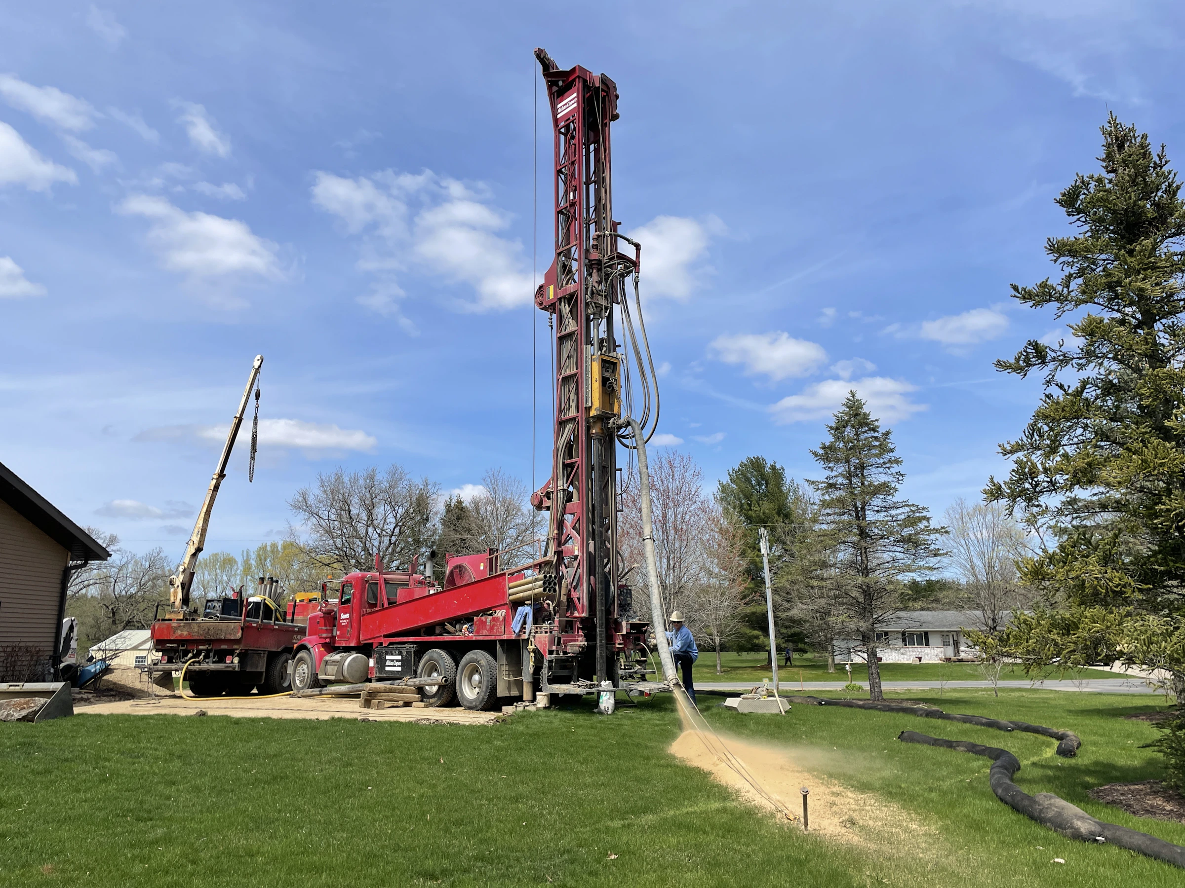 Water well drilling rig at work on site