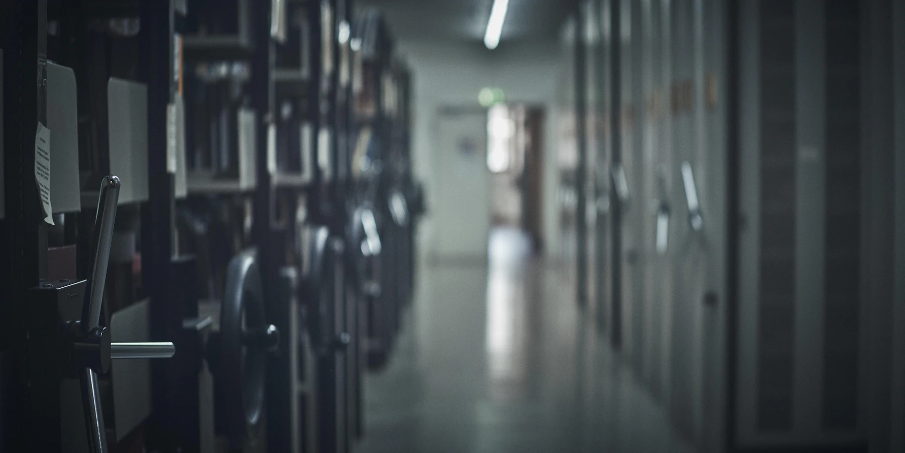 Rows of filing cabinets receding down a dim hallway
