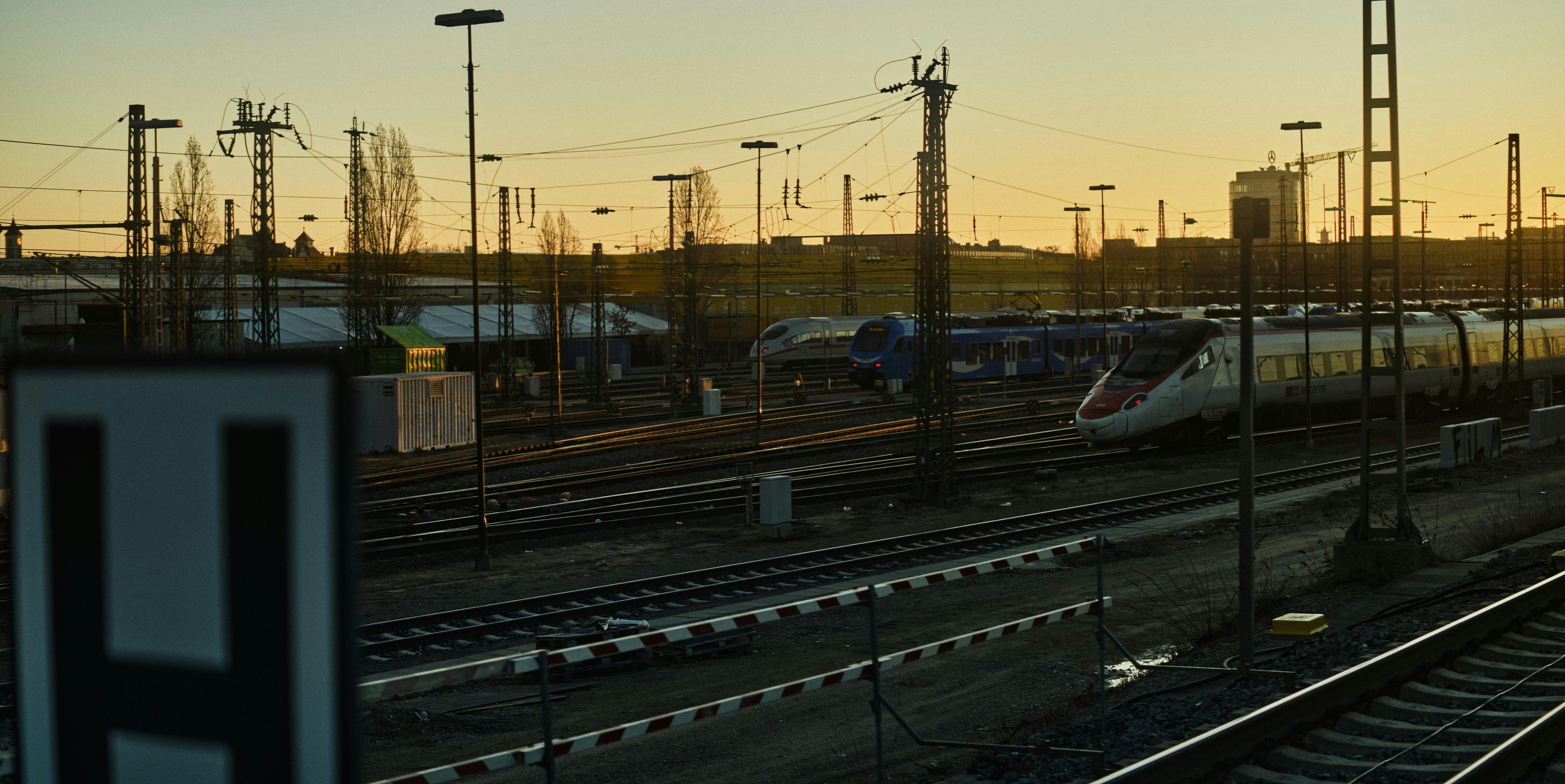 Train on the tracks at sunset.