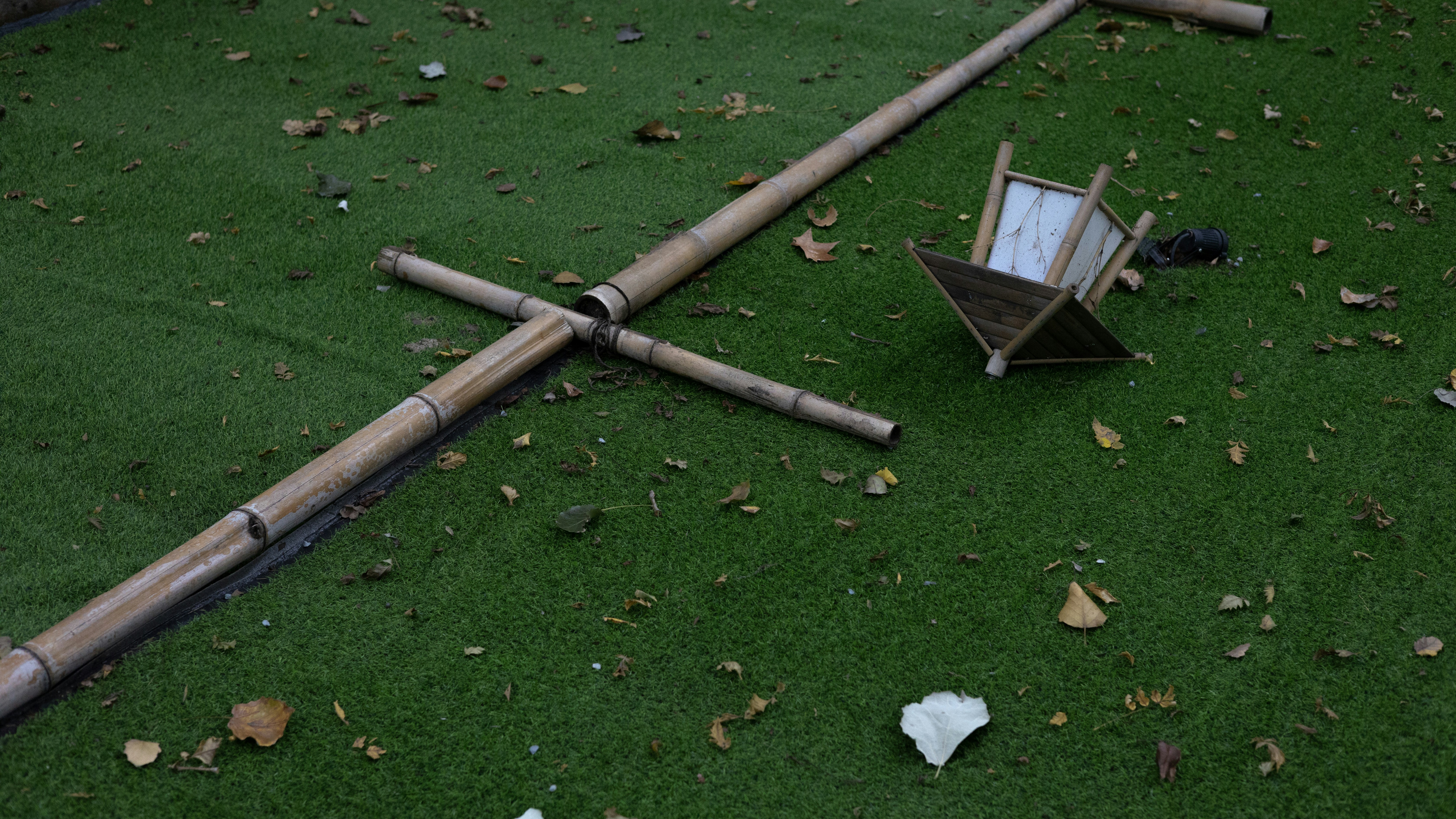 Fallen Bamboo Lantern & Structure on Leaf-Strewn Grass