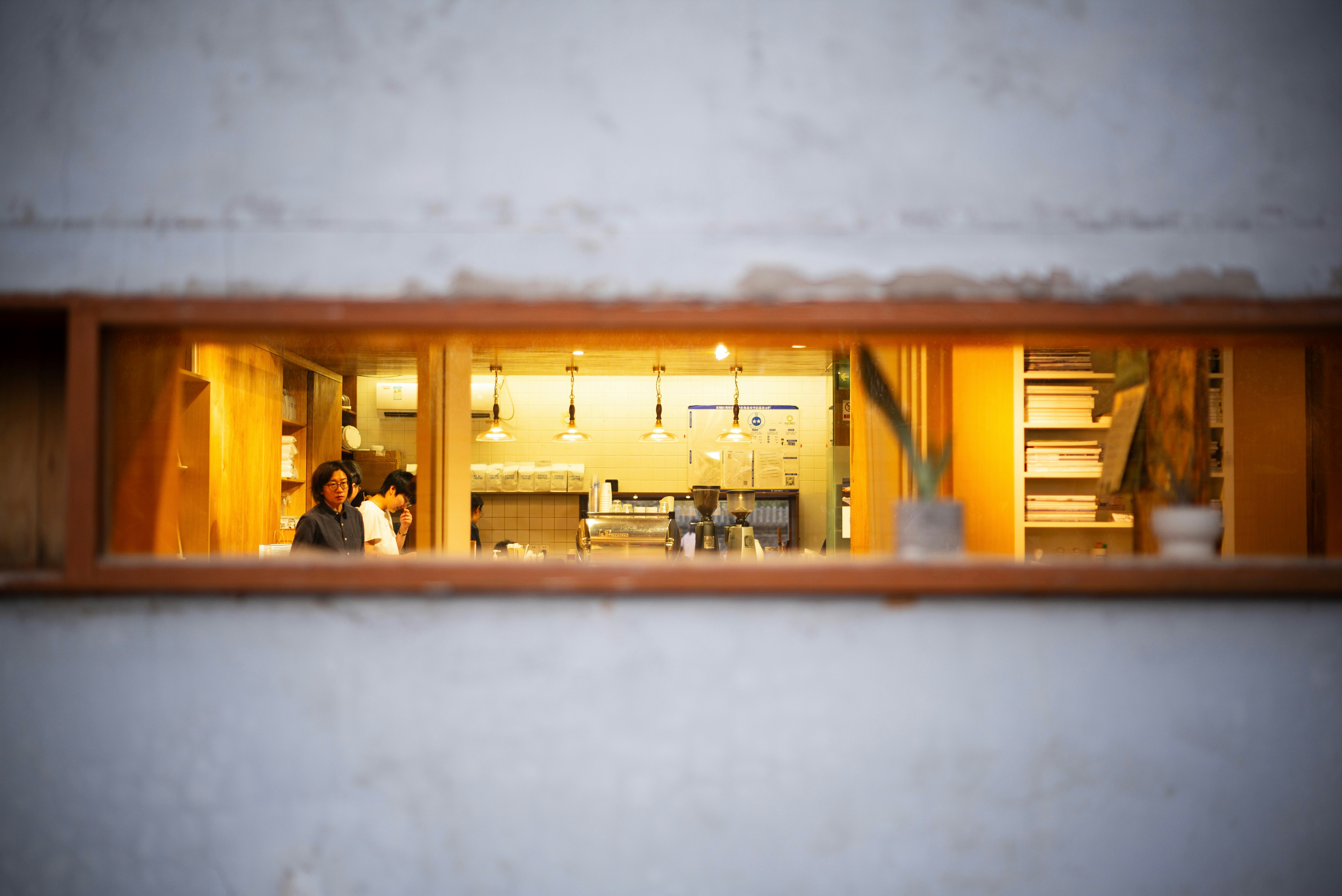 People are inside a warmly lit building.