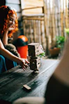 Woman plays jenga game on a wooden table.