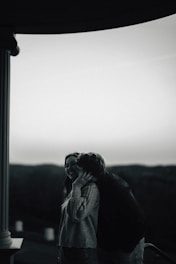 A couple shares a tender moment outdoors.