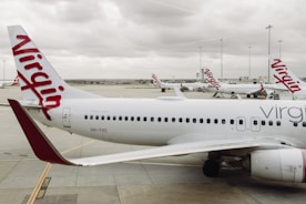 Virgin australia planes are on the ground at the airport.