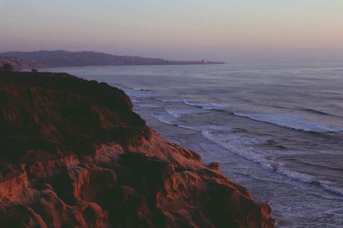 Sunset over the Algarve coastline from a clifftop hiking trail