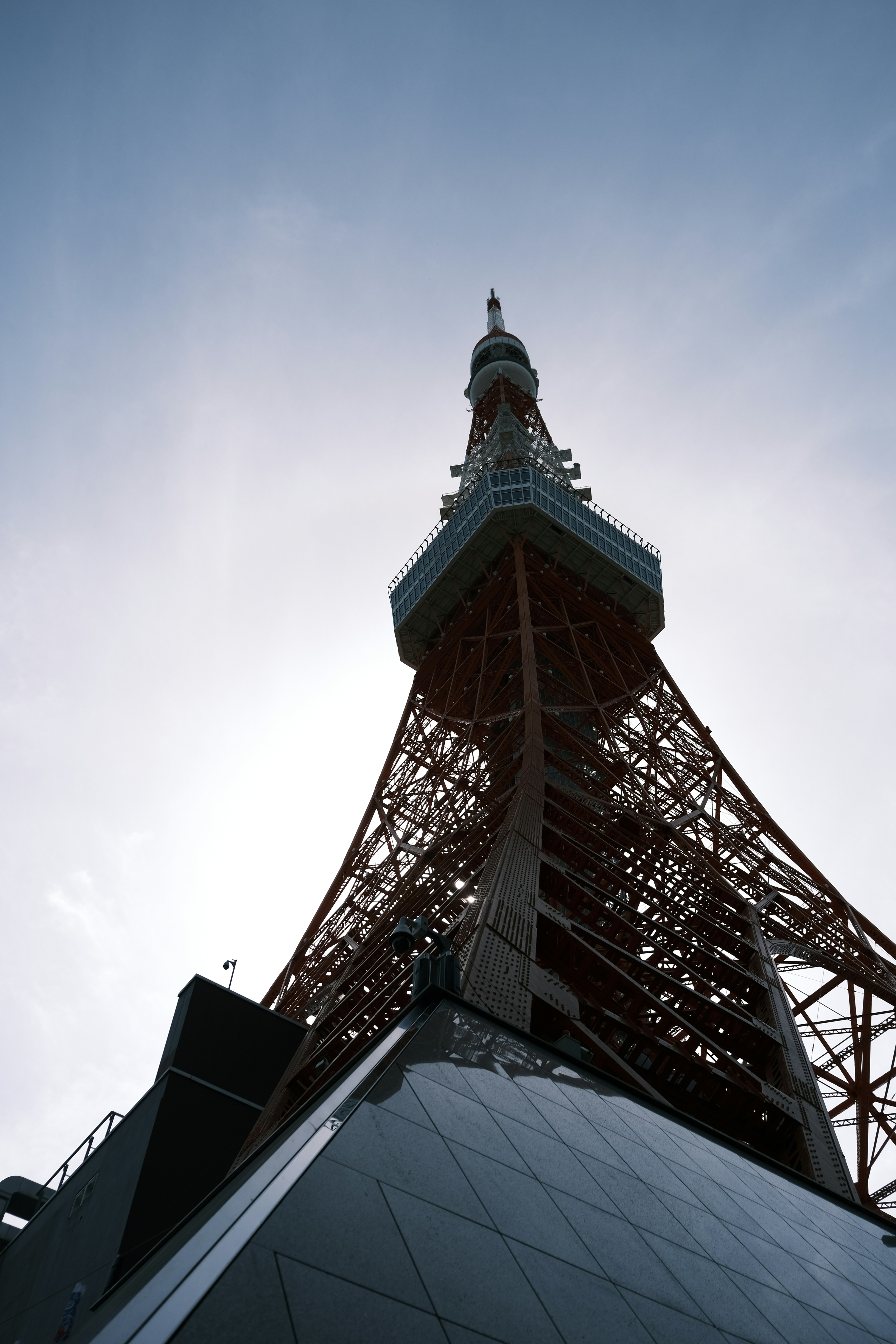 Tokyo tower is seen from a low angle.