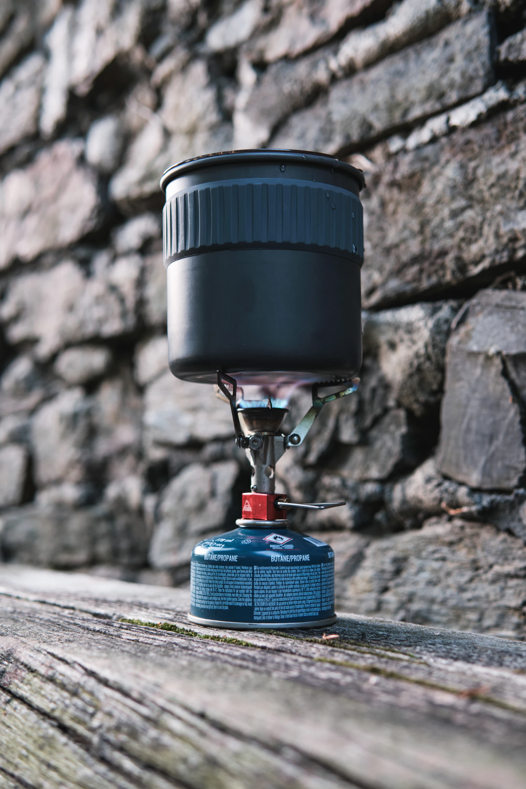 Cooking pot heating on a compact portable camping stove outdoors