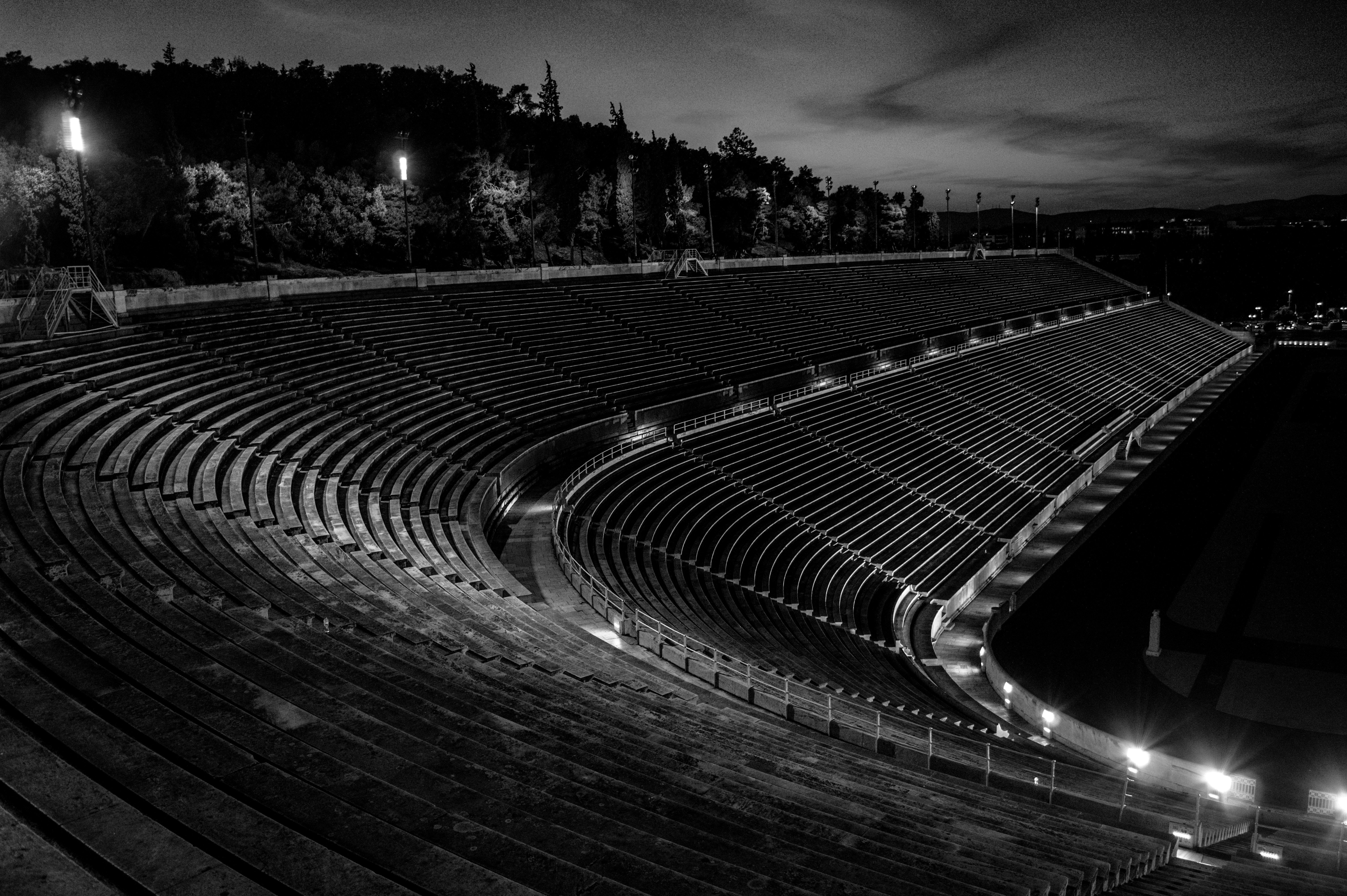An empty stadium at night, in black and white.