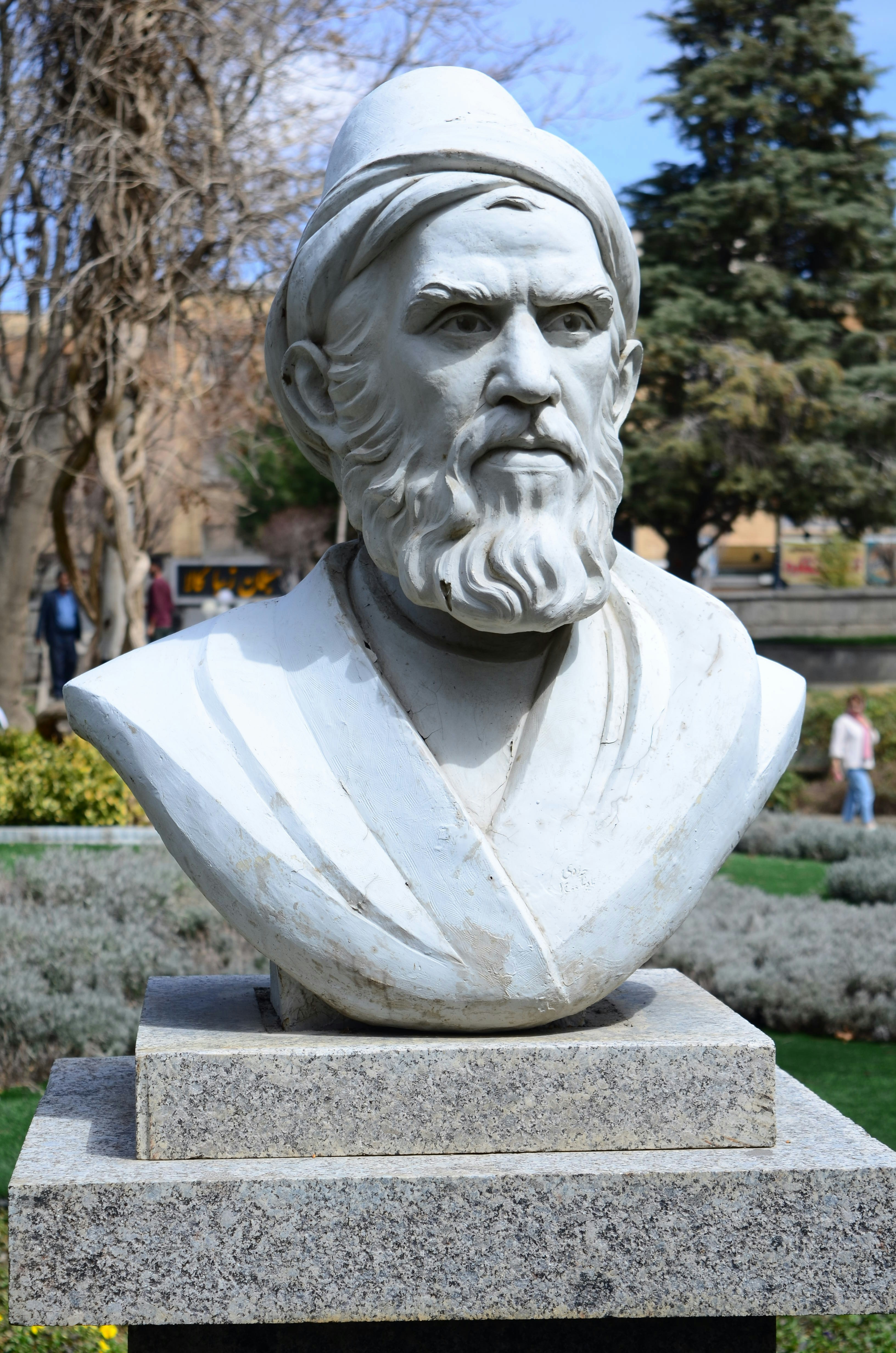 A stone bust of a man with a beard.