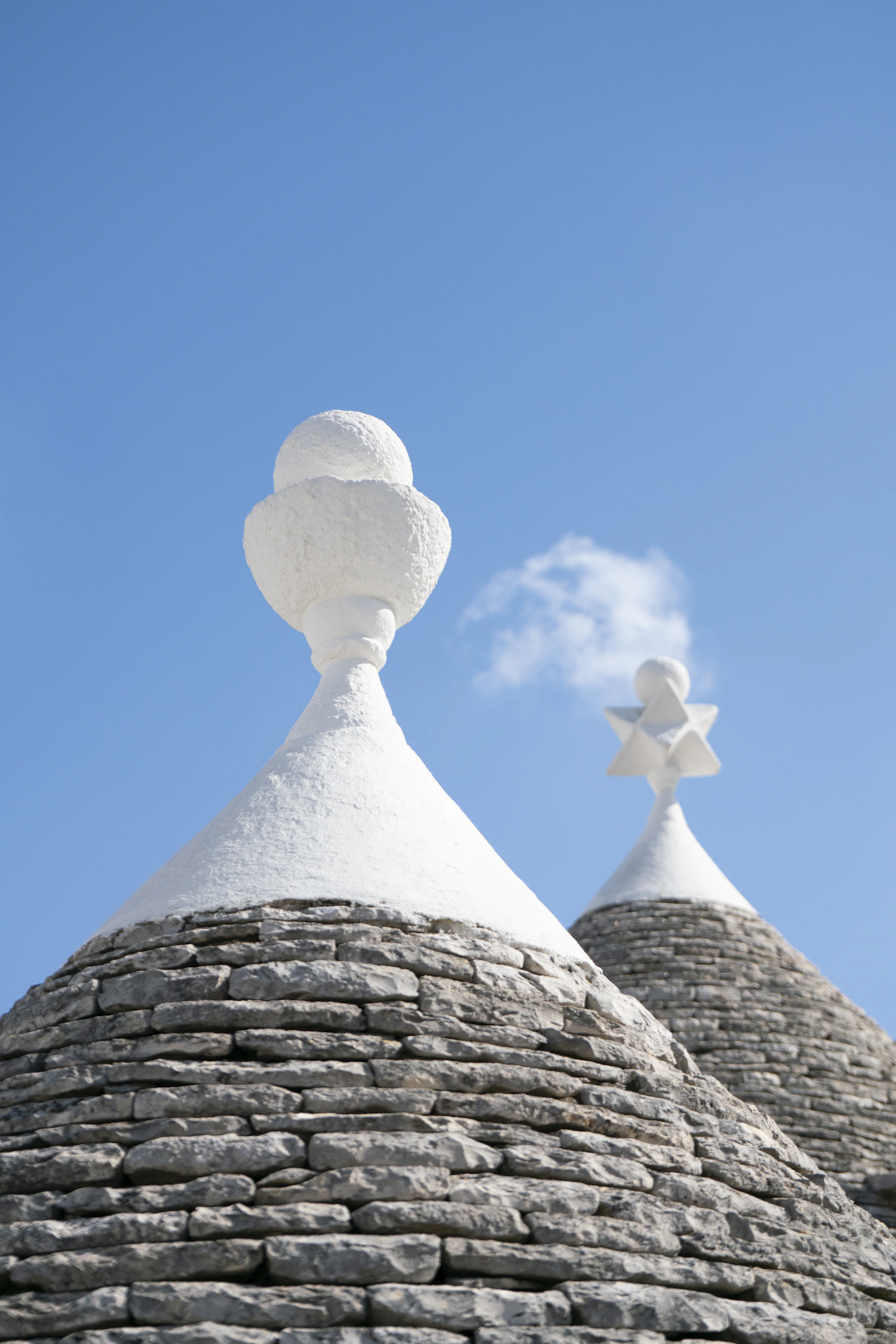 Stone and whitewashed rooftops under a blue sky.