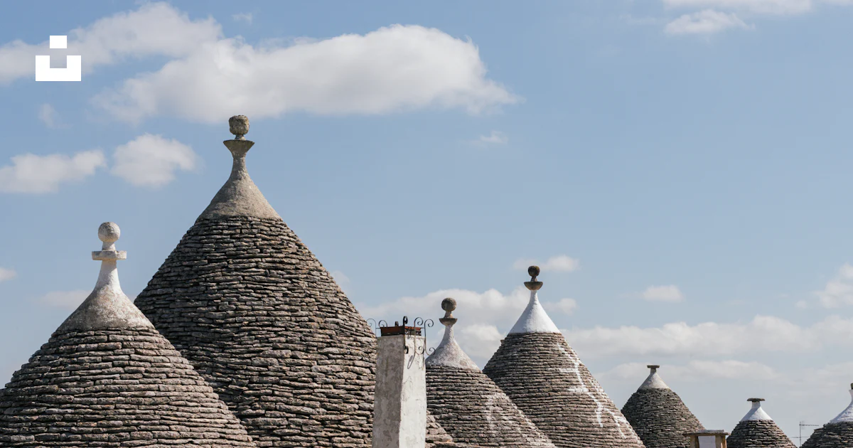 Stone houses with conical roofs under a blue sky. photo – Free Building ...