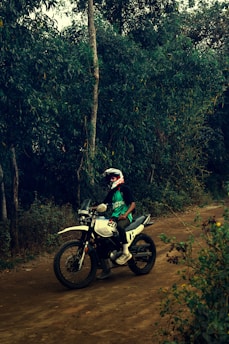 A person rides a motorcycle on a trail.